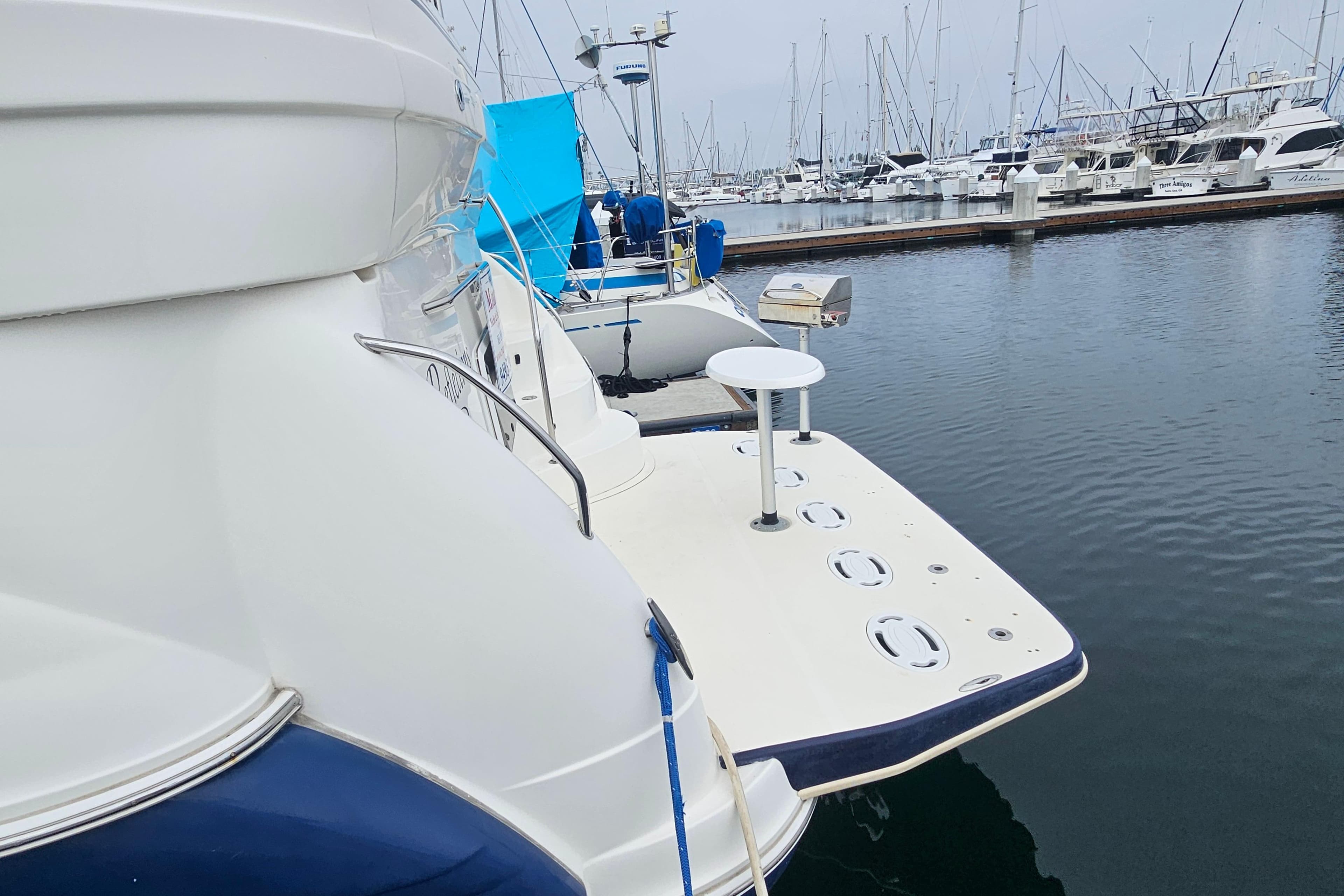 2005 Sea Ray 390 Motor Yacht docked in a marina, surrounded by other boats.