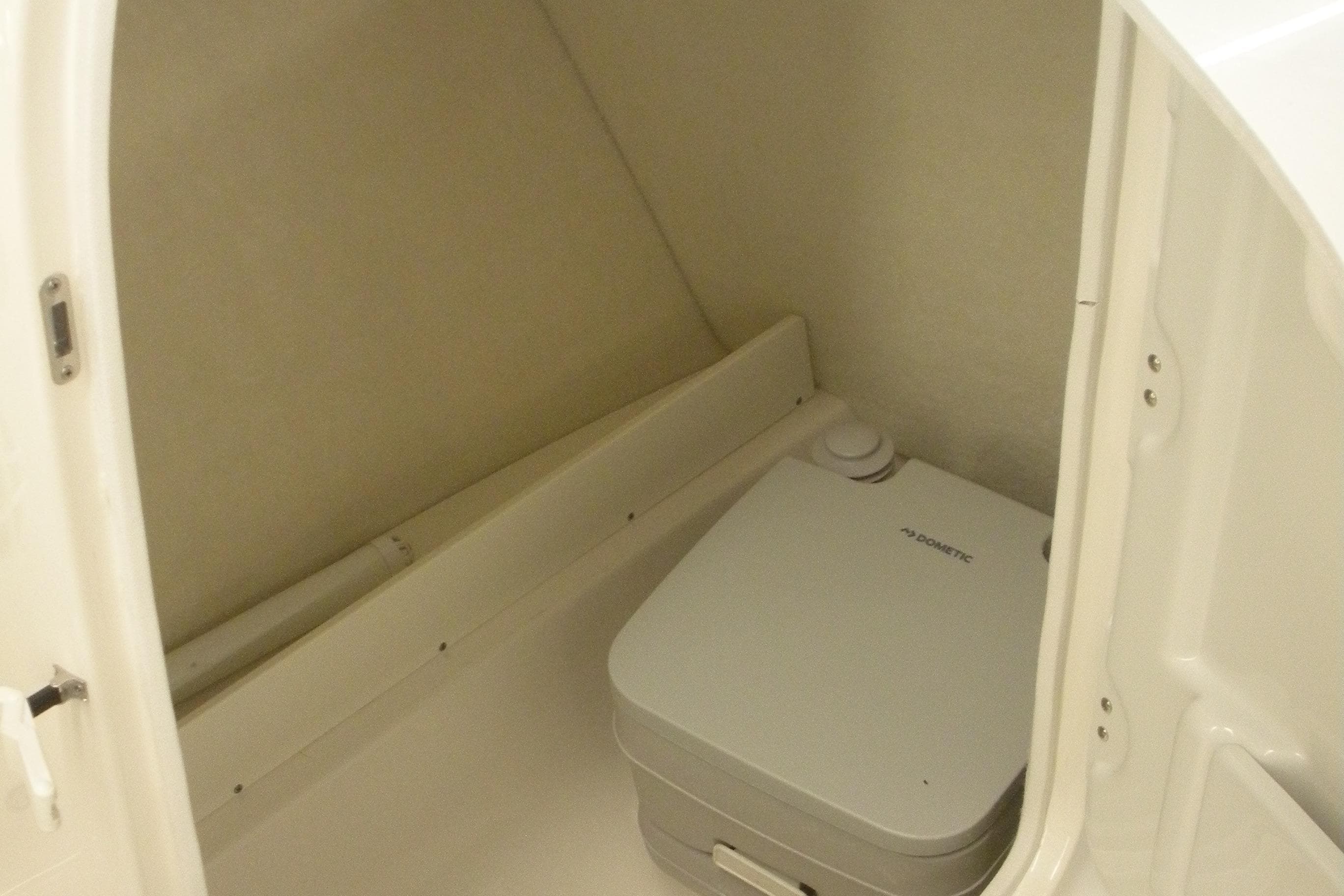 2026 Robalo R207 Dual Console boat interior with compact marine toilet.