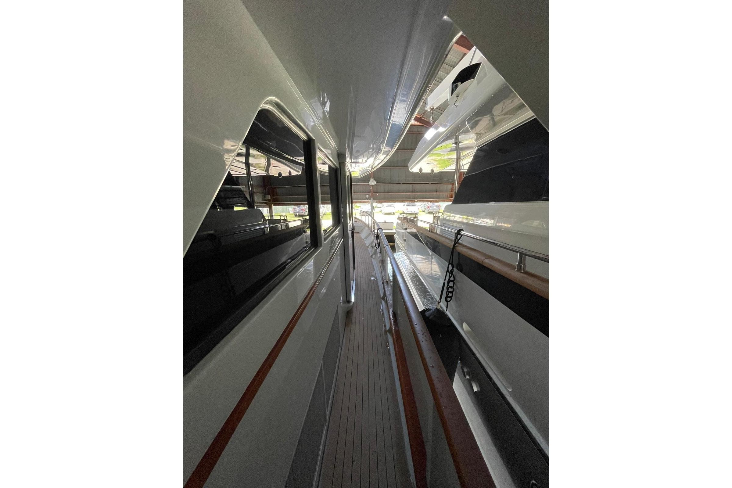 1988 Burger Classic Motoryacht side deck view, showcasing sleek design and polished wood accents.