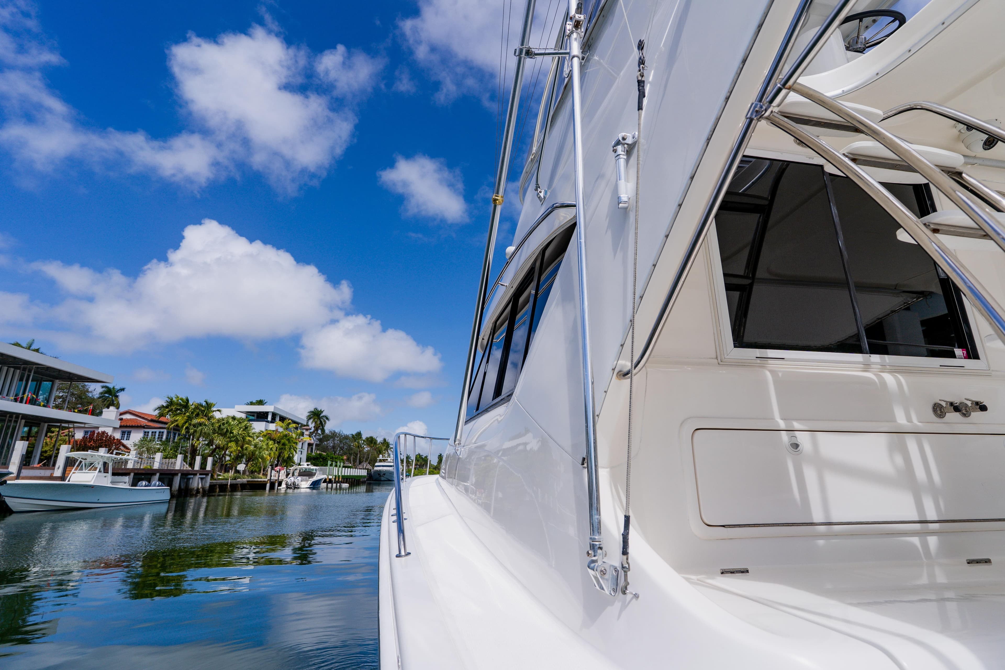 2003 Wellcraft 400 Coastal yacht docked in a scenic waterfront area under a blue sky.