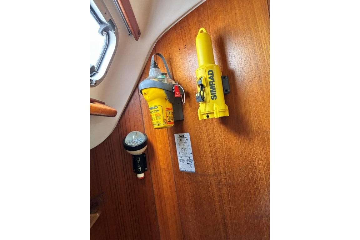 Safety equipment on 1994 X-Yachts X-442, featuring Simrad devices mounted on wooden panel.