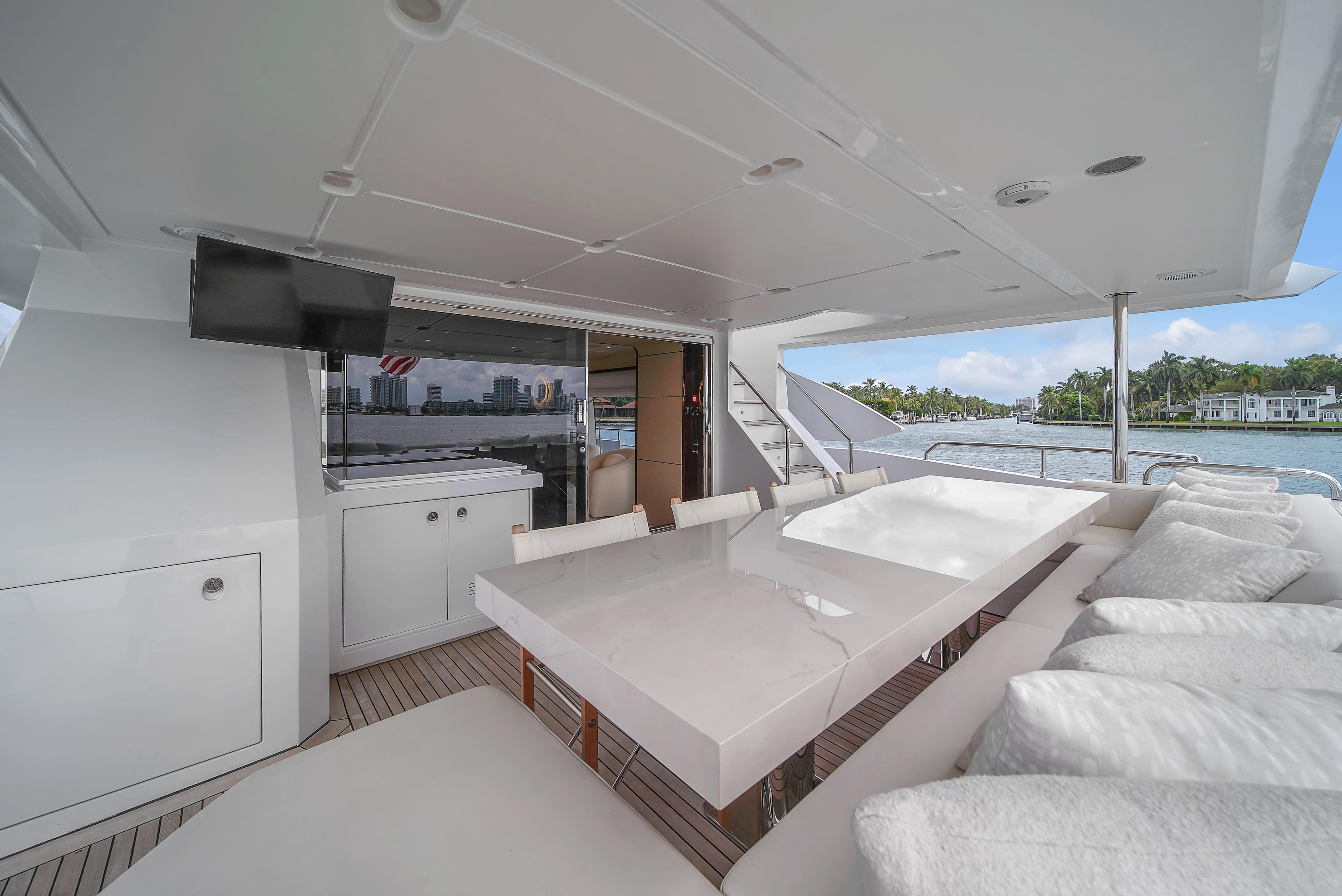 Luxurious 2017 Azimut 95 Raised Pilothouse yacht deck with elegant seating and dining area.
