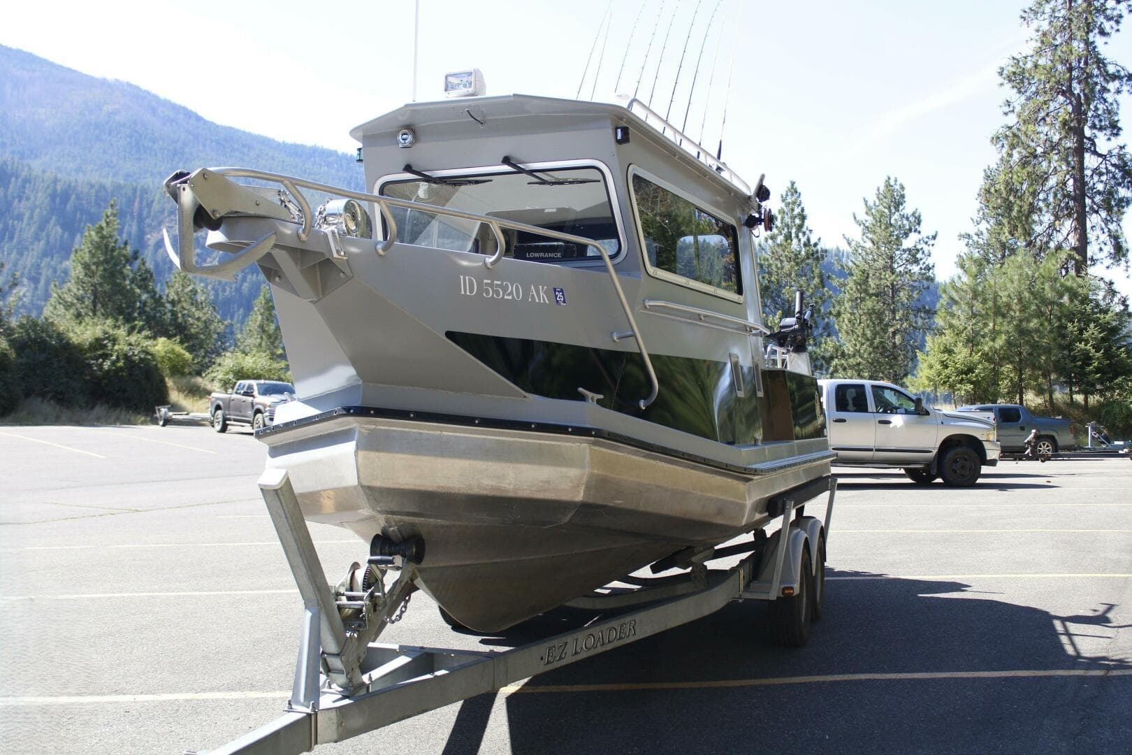 2005 ACB 27 boat on trailer in scenic mountain parking lot.
