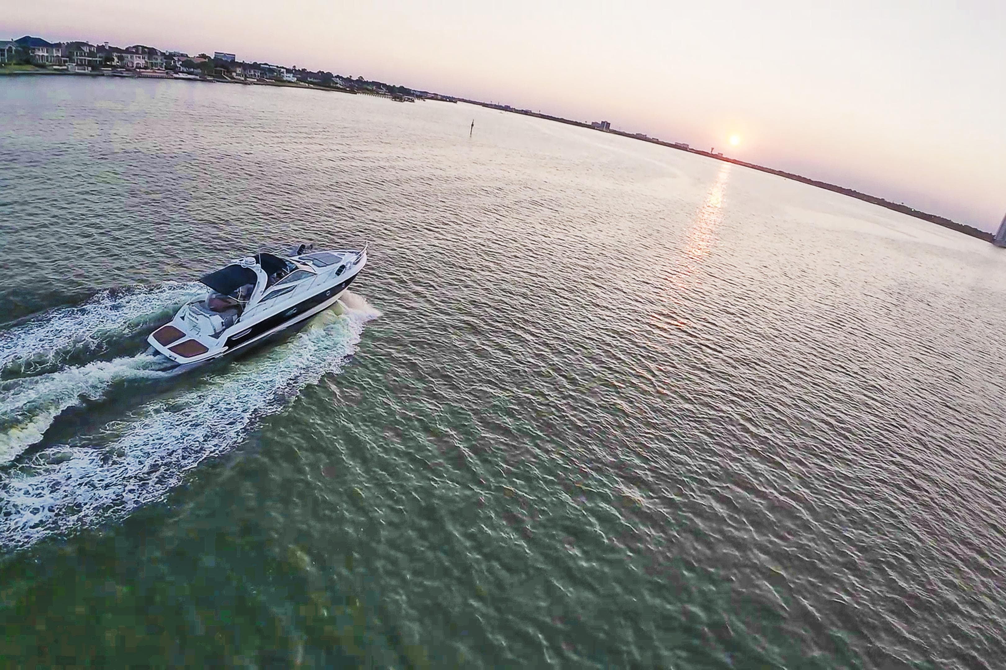 2008 Cranchi Mediterranee 43 yacht cruising at sunset on open water.