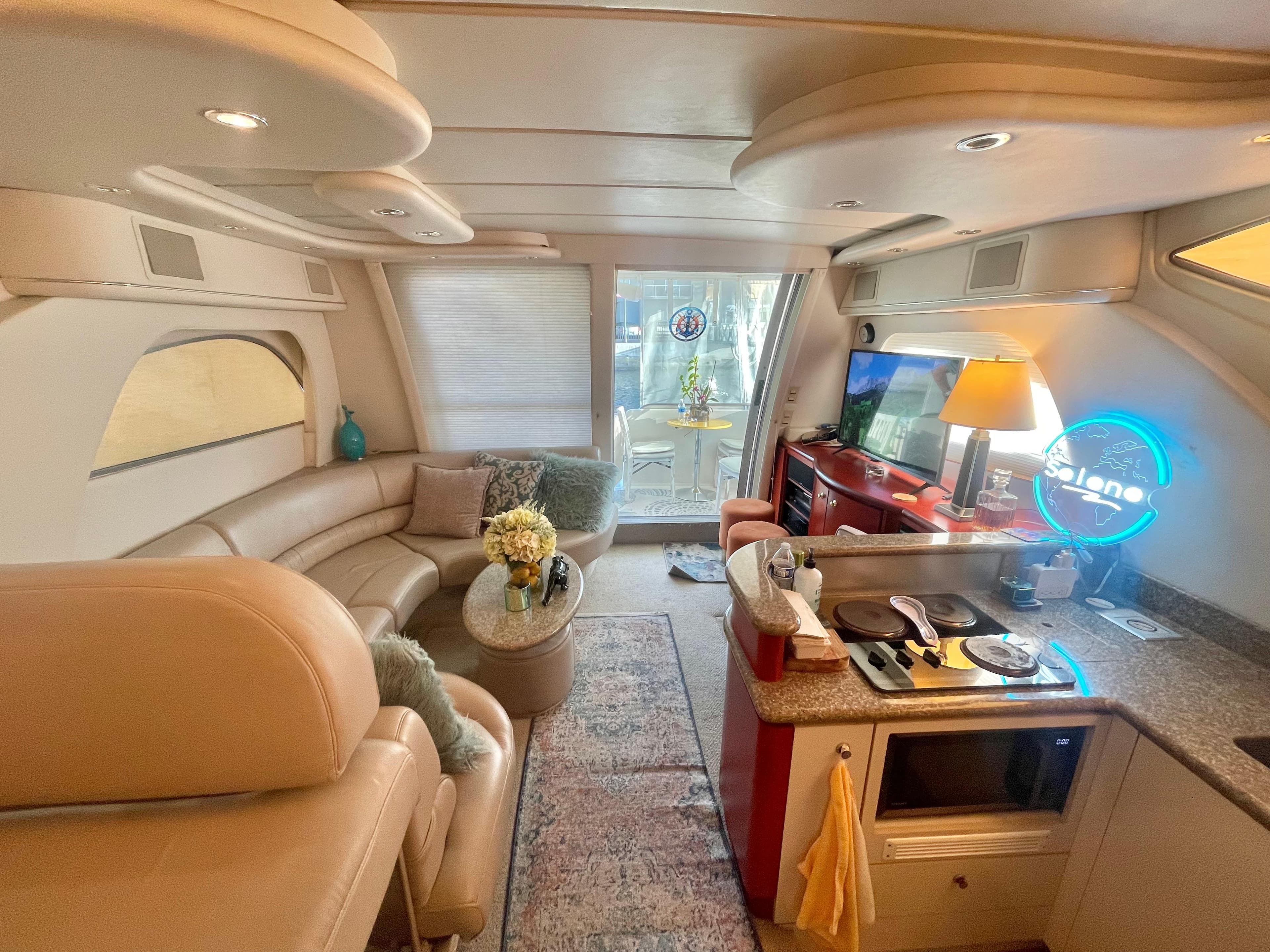 Luxurious interior of a 1998 Maxum 4100 SCA yacht with modern amenities and cozy seating.