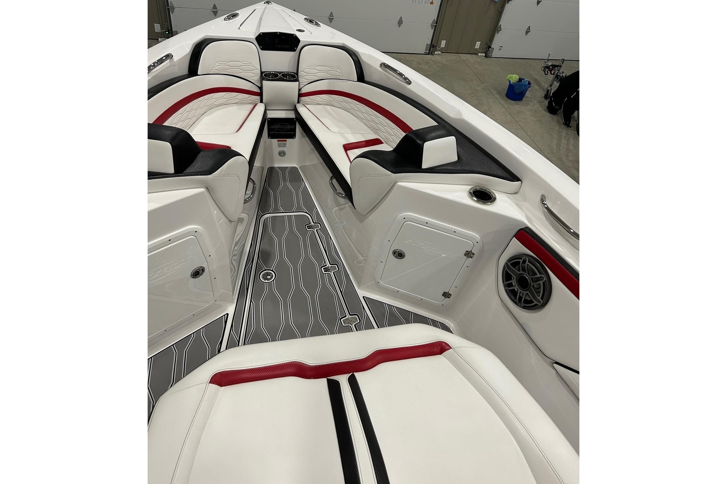 2023 Sunsation 32 CCX boat interior with red and black accents, modern seating, and sleek design.