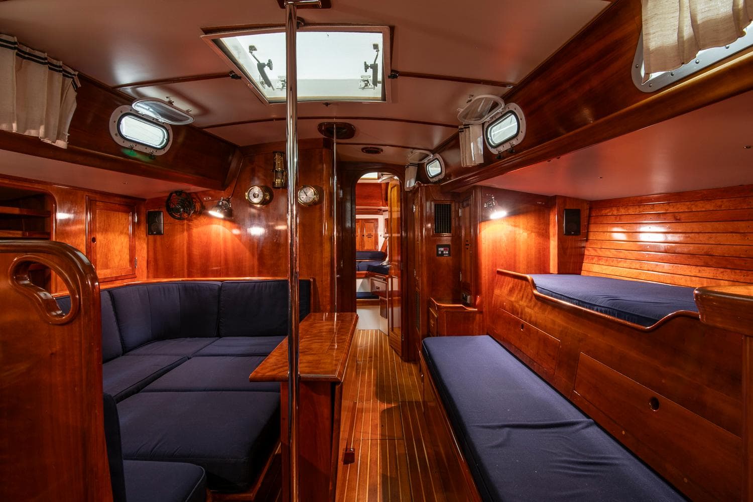 Interior of 1994 Hinckley Sou'wester 42 Sloop with wooden finish and blue seating.