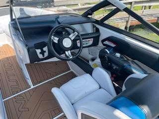 2017 Nautique Super Air Nautique G23 interior with steering wheel and seating.