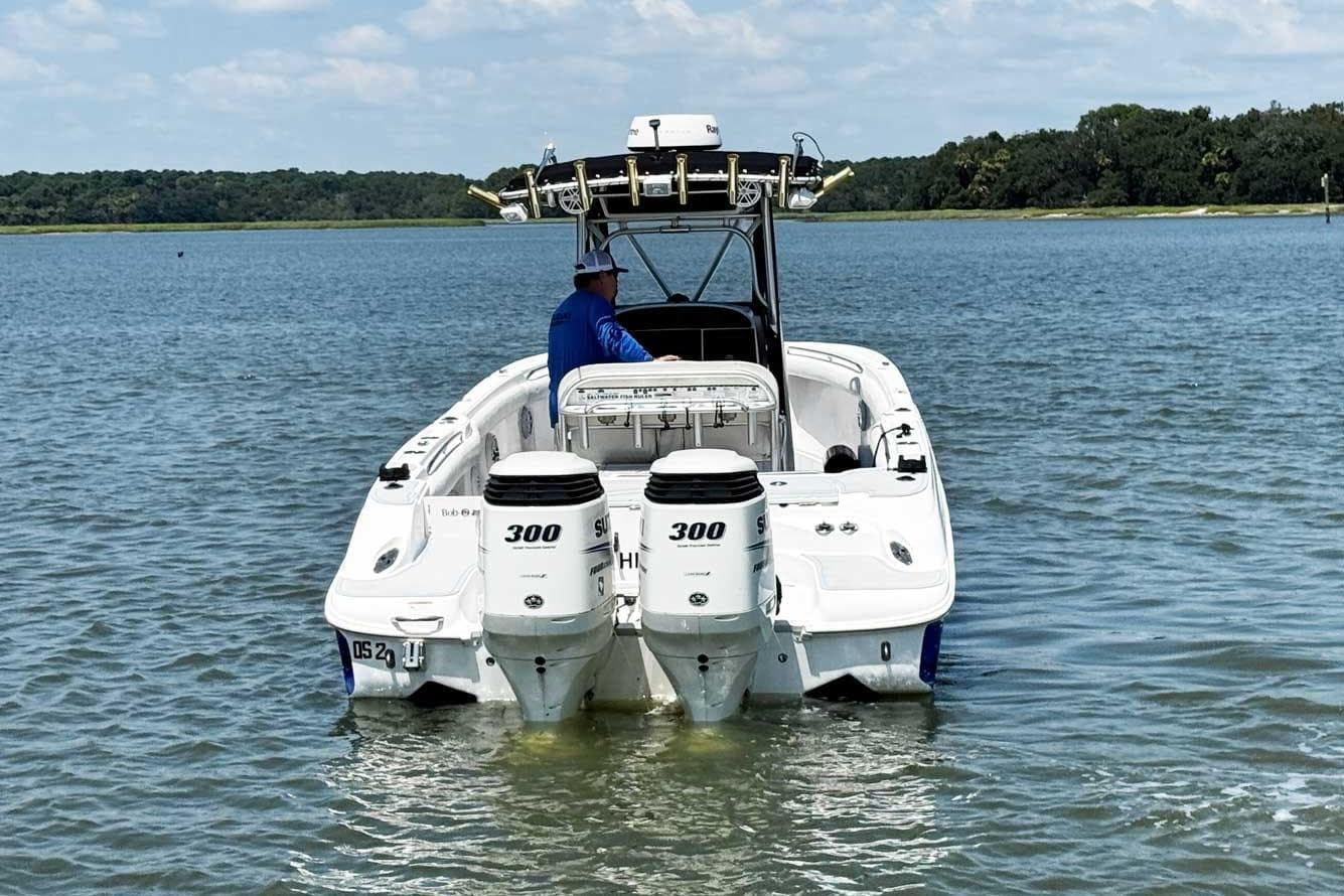 2005 Wellcraft 32 CCF boat with dual 300 HP engines on calm water.