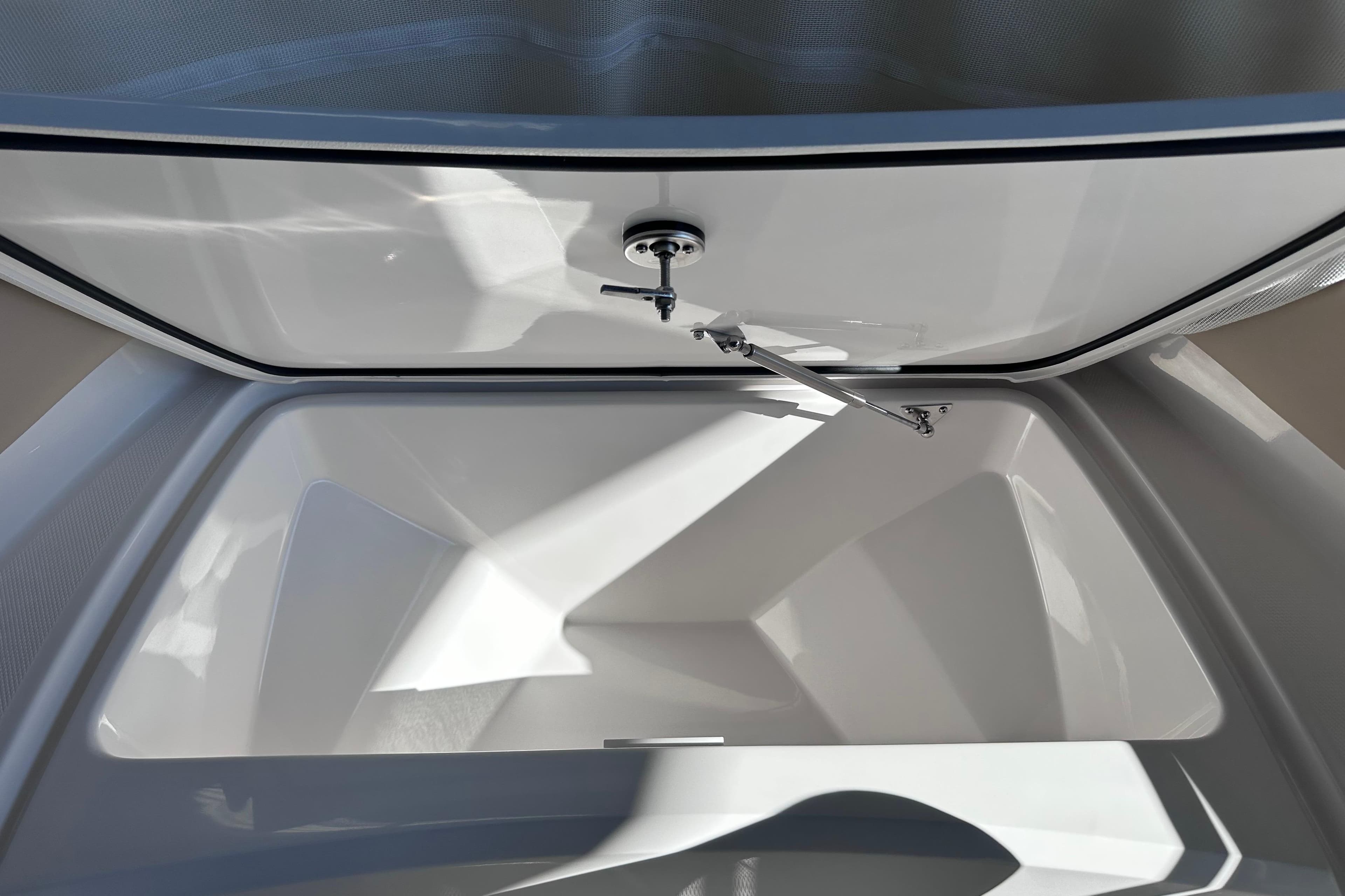Open storage compartment of 2026 Edgewater 170CC boat, showcasing spacious interior design.