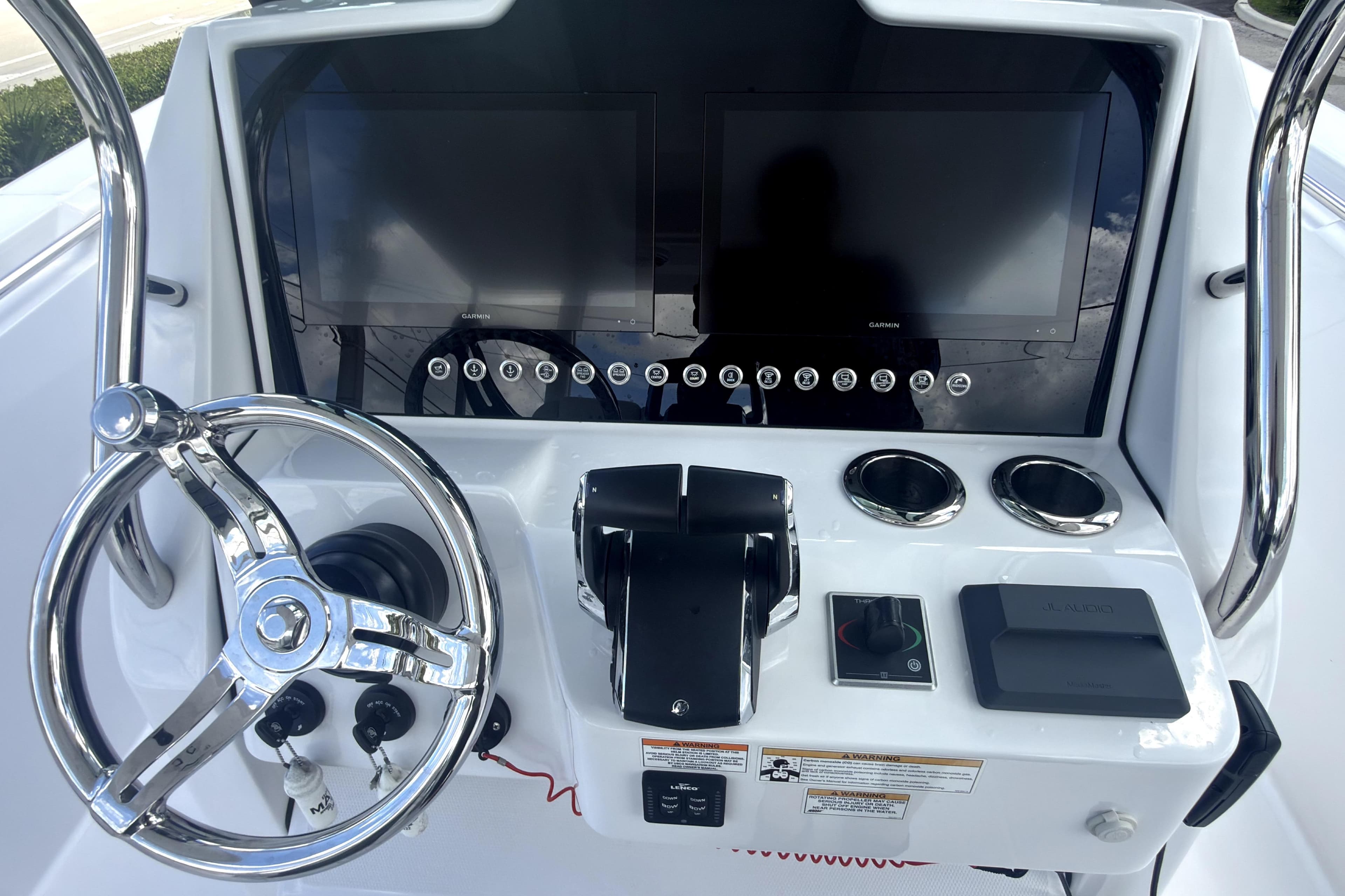 2023 Bertram 28 CC boat dashboard with dual screens and steering wheel.
