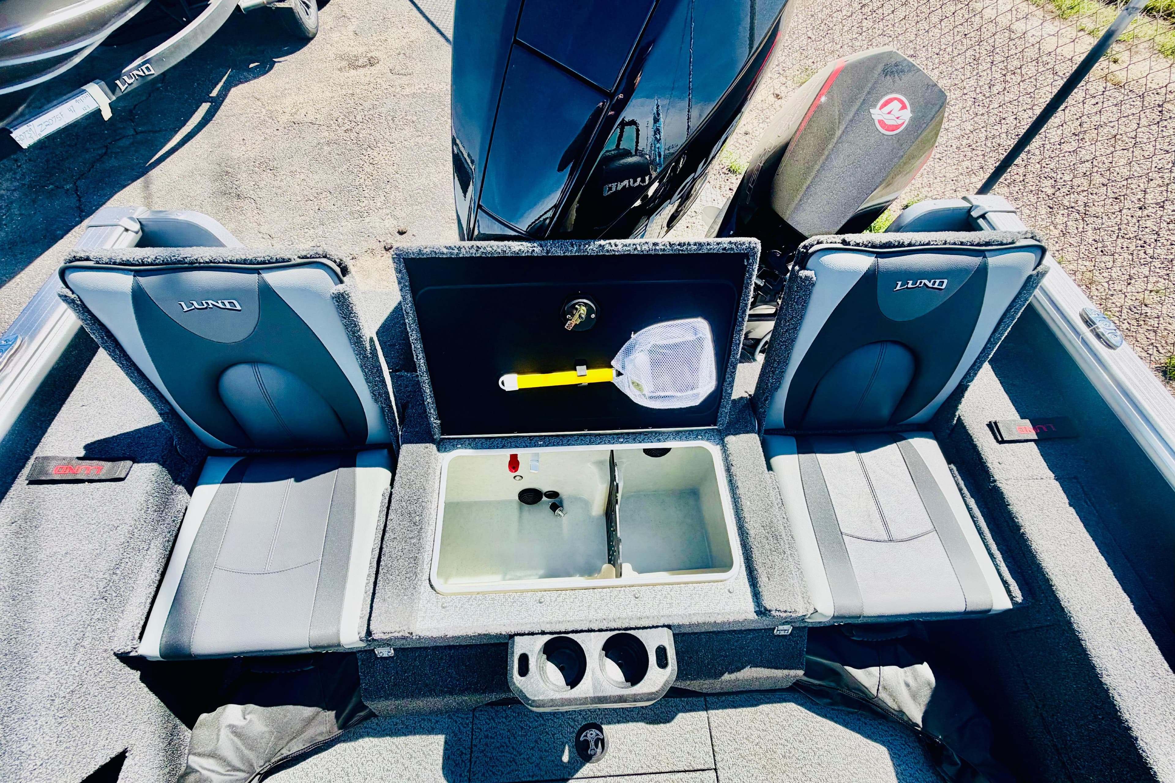 2026 Lund 2075 Impact XS boat interior with seating and storage compartments.