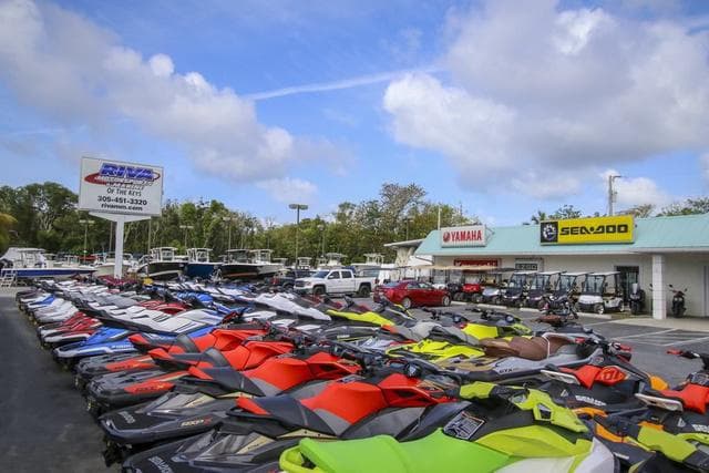 2021 Skeeter SX210 boats and jet skis at dealership with Yamaha and Sea-Doo signage.