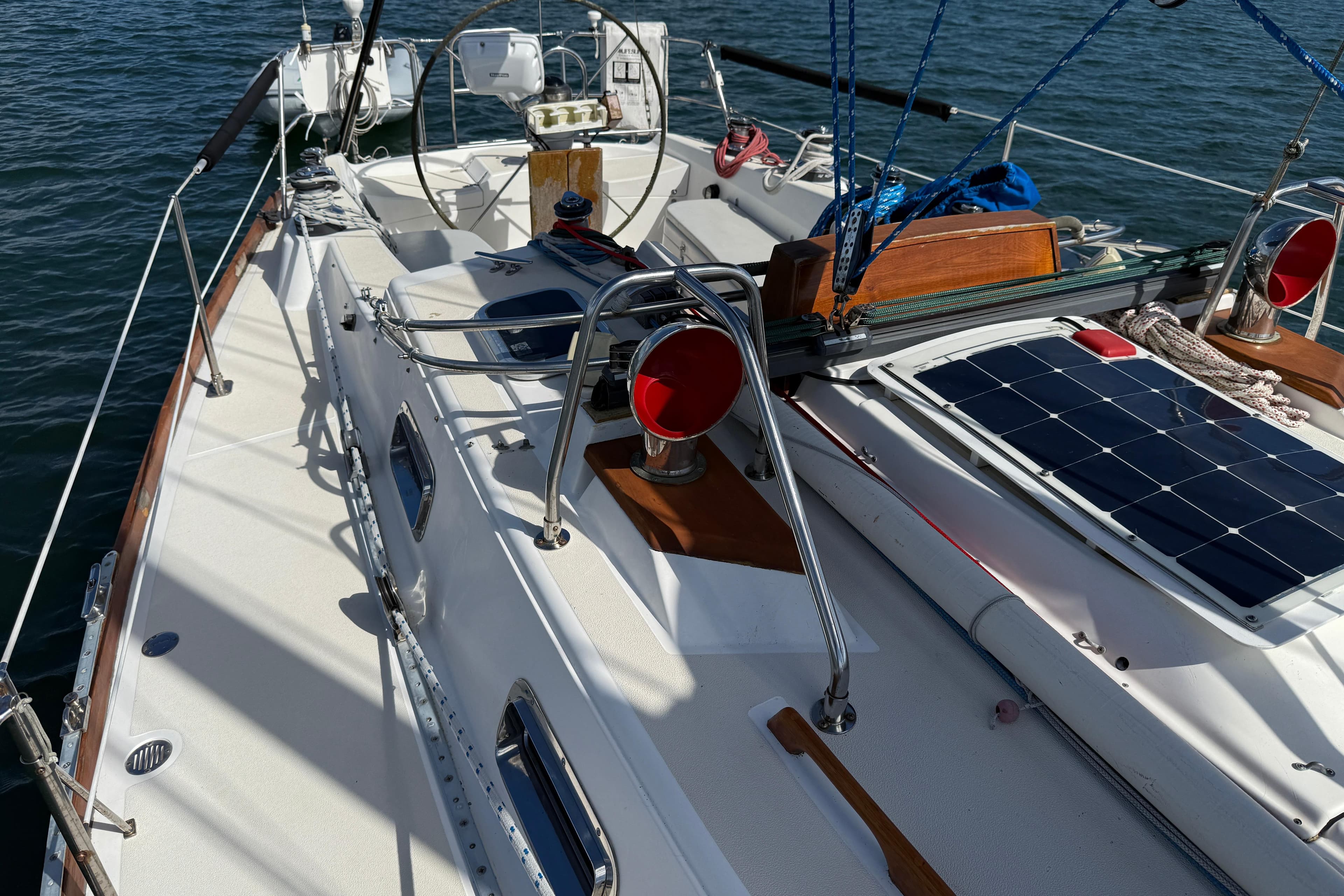 Sailboat deck of 1997 Tartan 3800 with solar panel and nautical equipment.