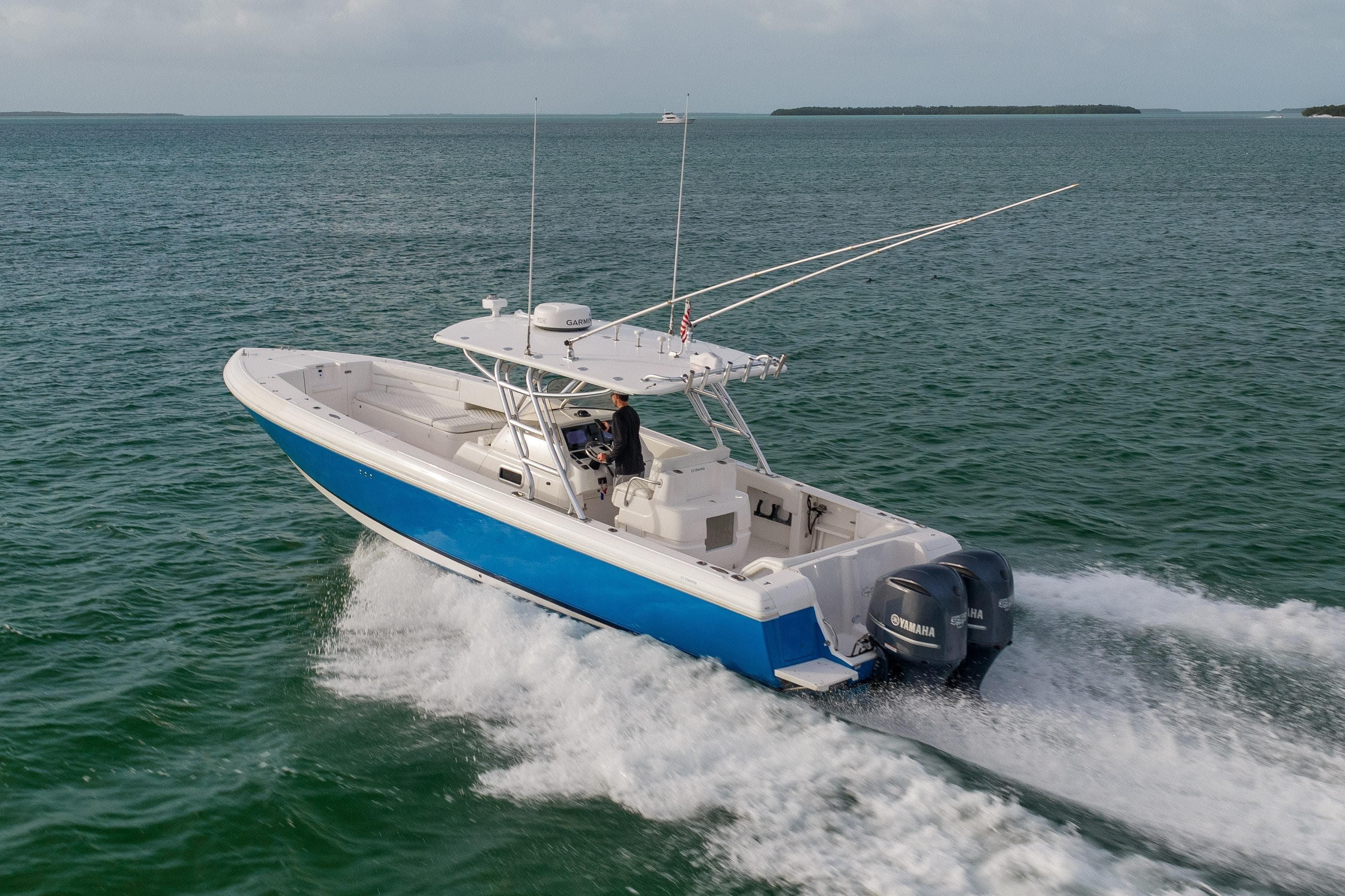 2011 Intrepid 370 Center Console boat cruising on open water with twin Yamaha engines.