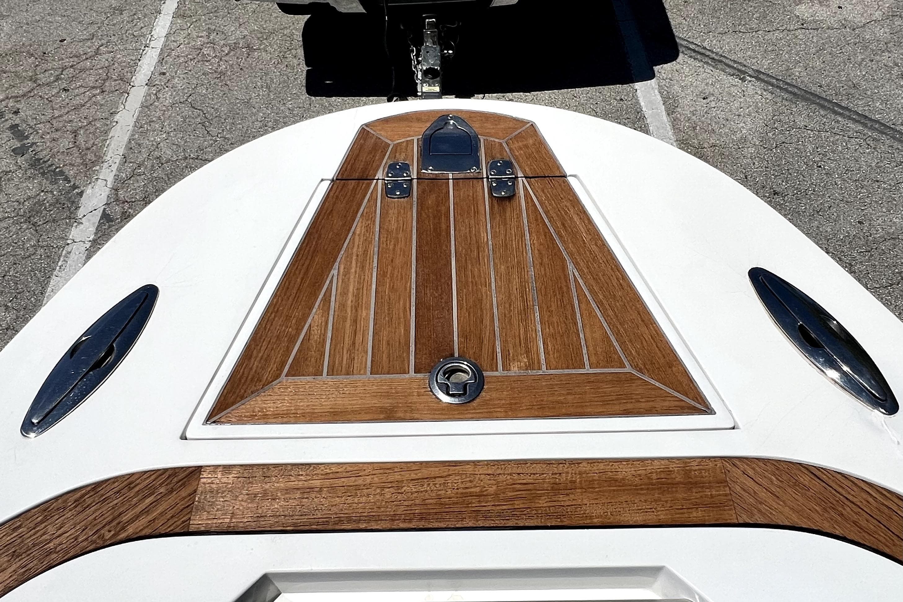 2013 Novurania Chase 23 boat deck with wood paneling and metal fixtures.