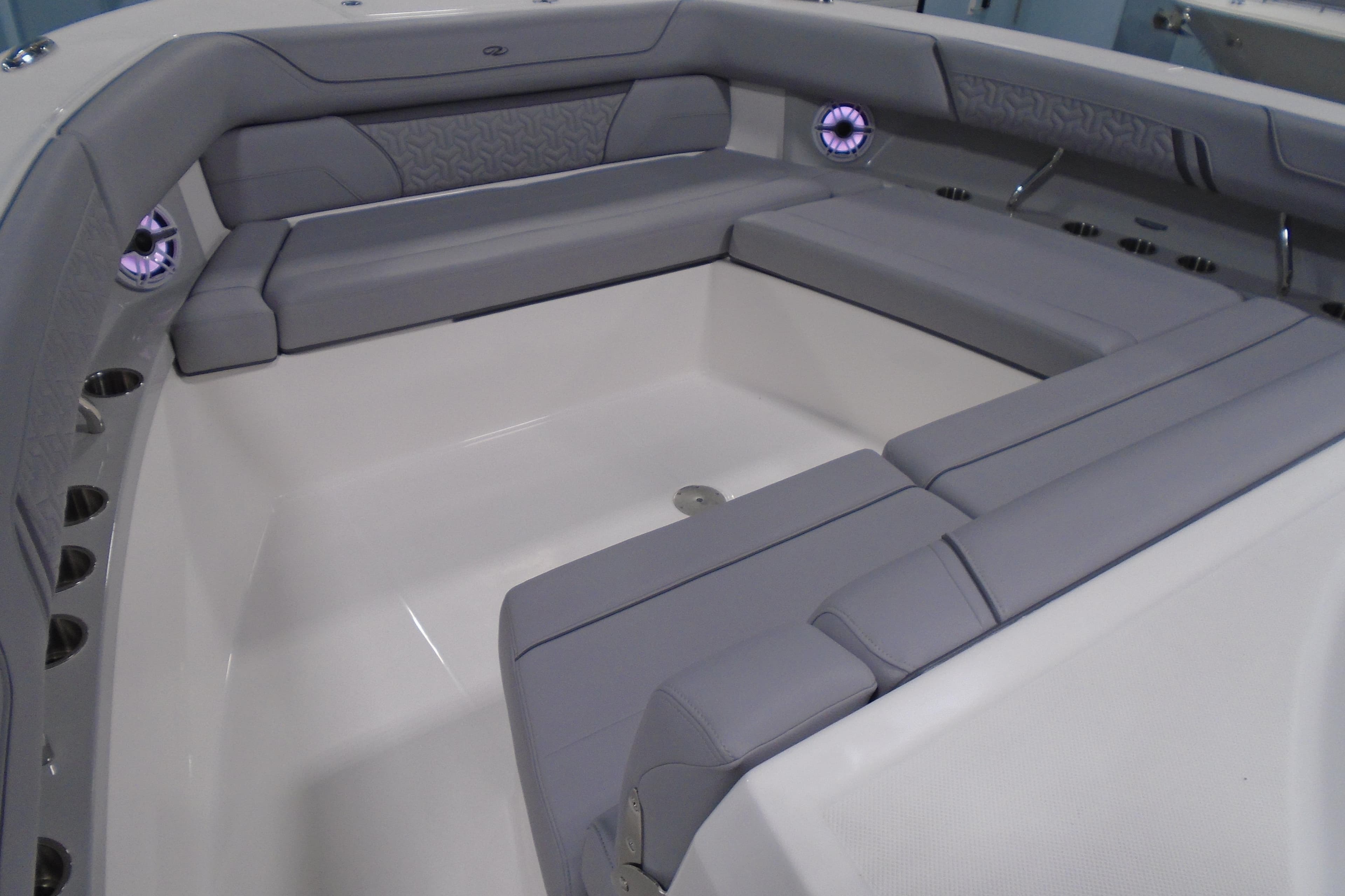 2026 Regal 38 SAV boat interior with gray seating and cup holders.