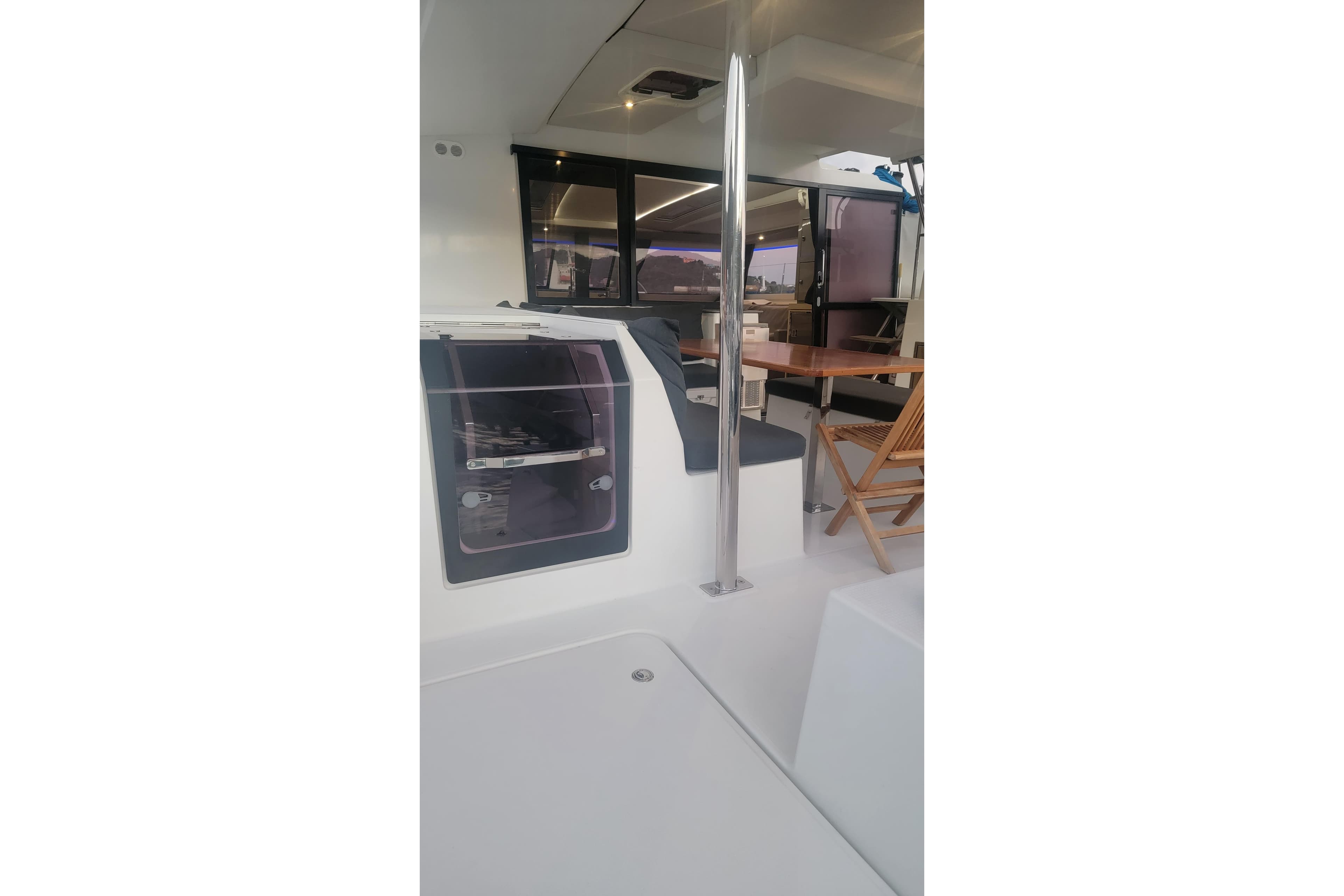 Interior view of 2019 Fountaine Pajot Saona 47 catamaran with seating and table.