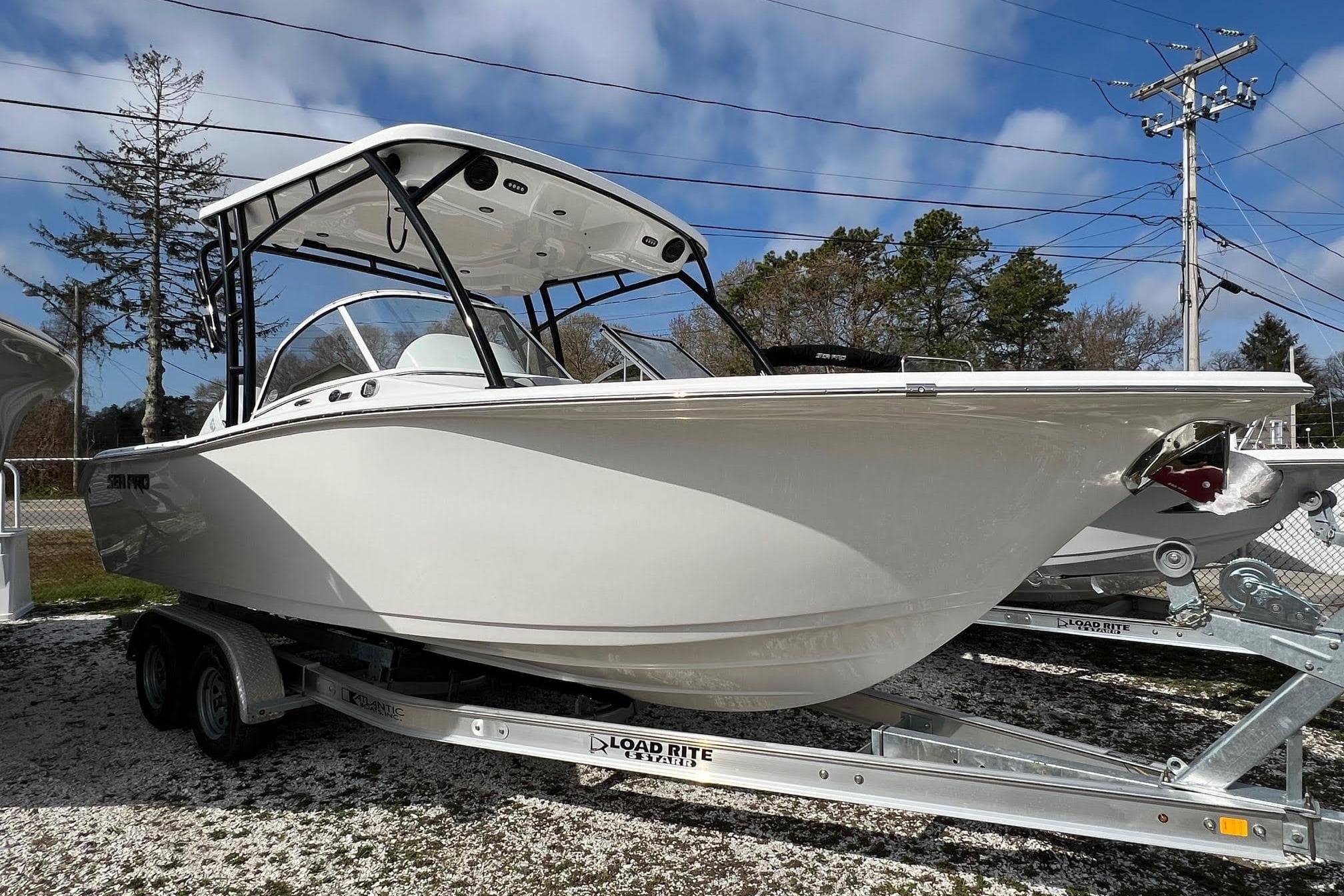 2026 Sea Pro 240 Dual Console boat on trailer under clear sky.