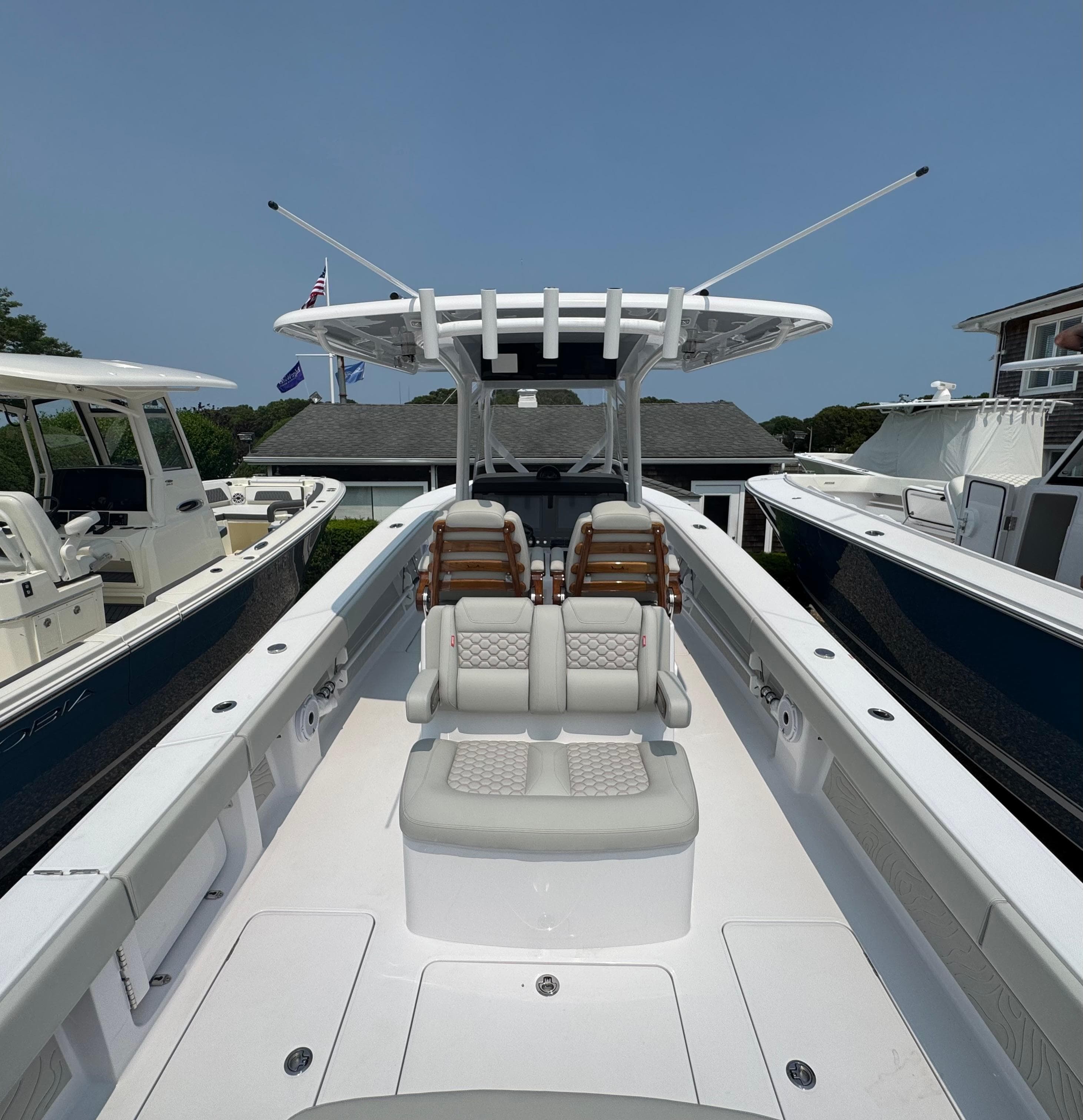 2026 Jupiter 32 boat with dual seats and sleek design, docked under clear blue sky.