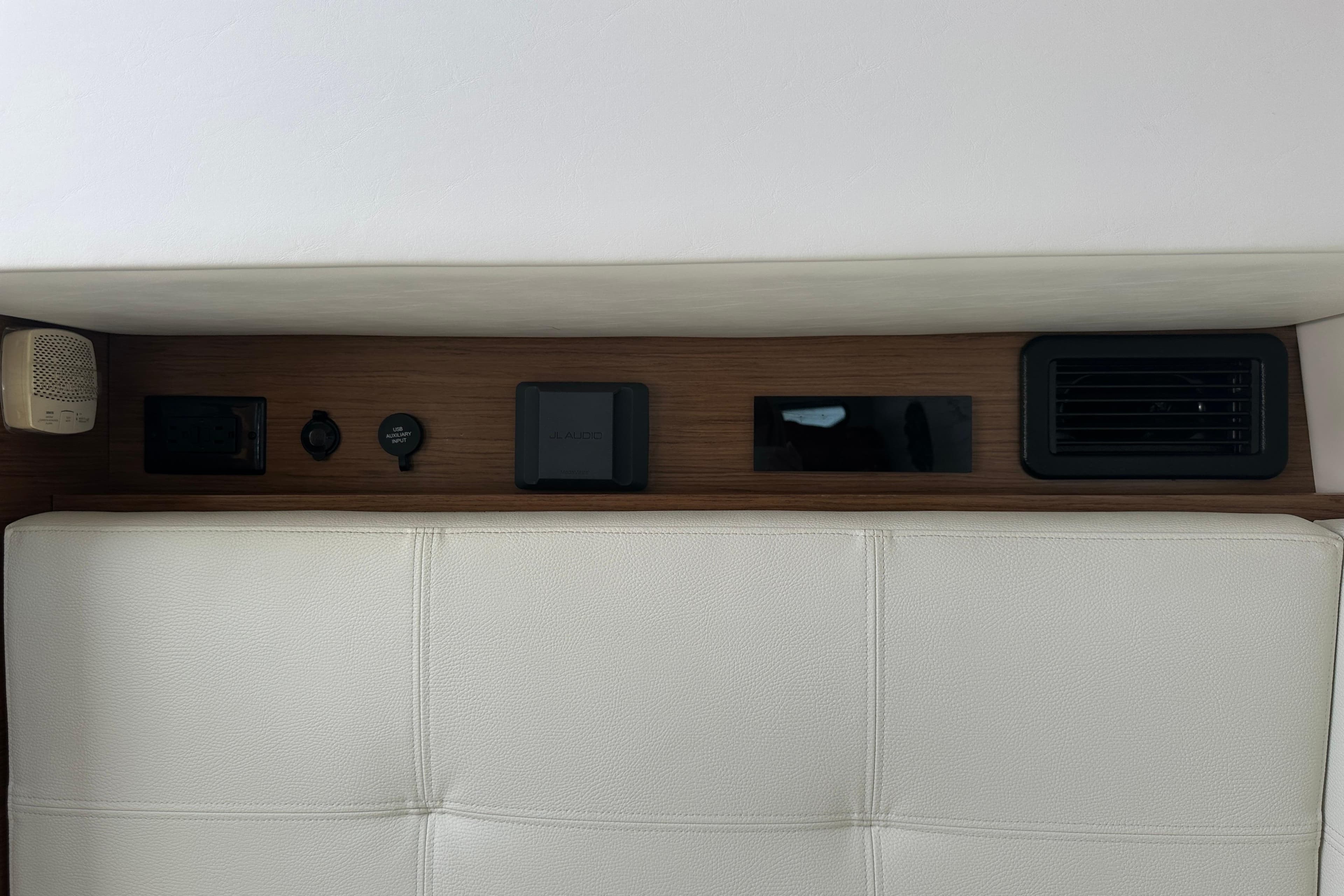 Interior view of 2019 Cruisers Yachts 338 Outboard, featuring control panel and speaker.