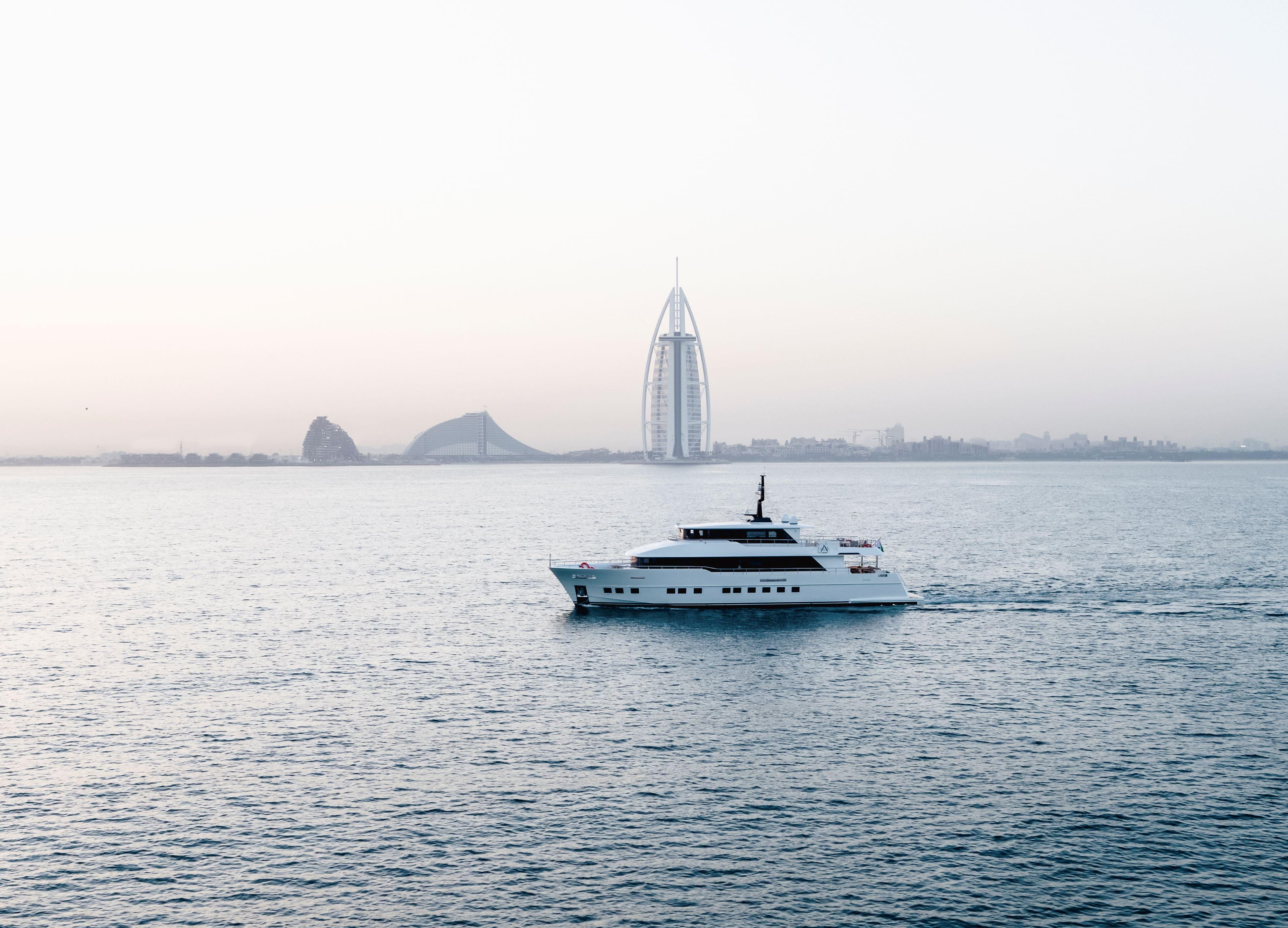 Luxury Nomad 95 SUV yacht cruising near iconic Dubai skyline, 2025.
