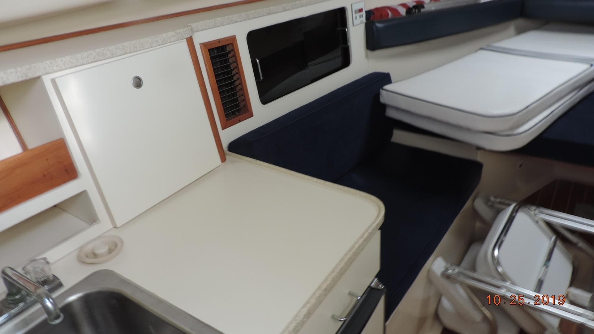 1998 Mainship 30 PILOT interior with kitchenette, sink, and seating area.
