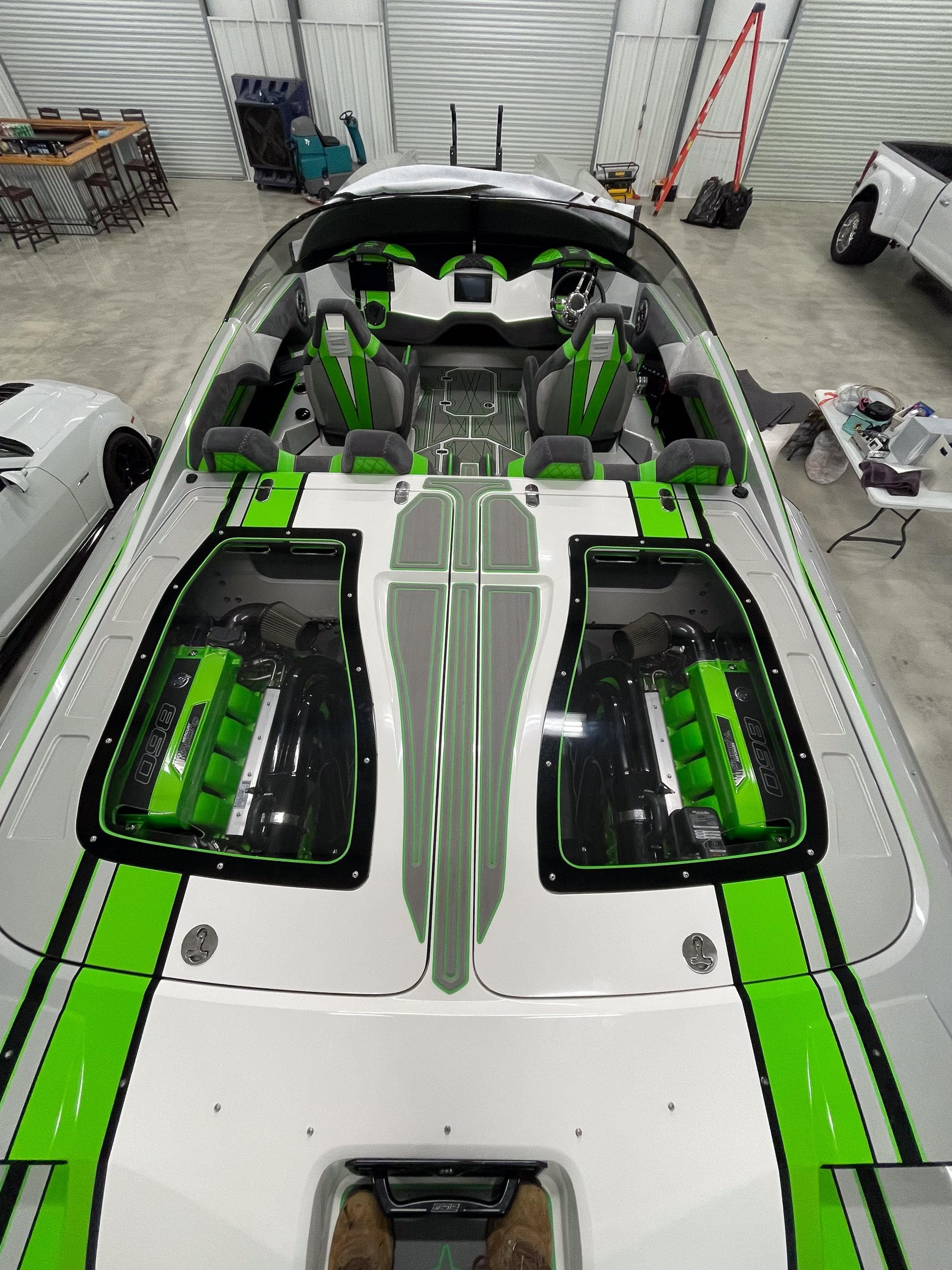 2018 Daves Custom Boats M31 with vibrant green accents in a garage setting.