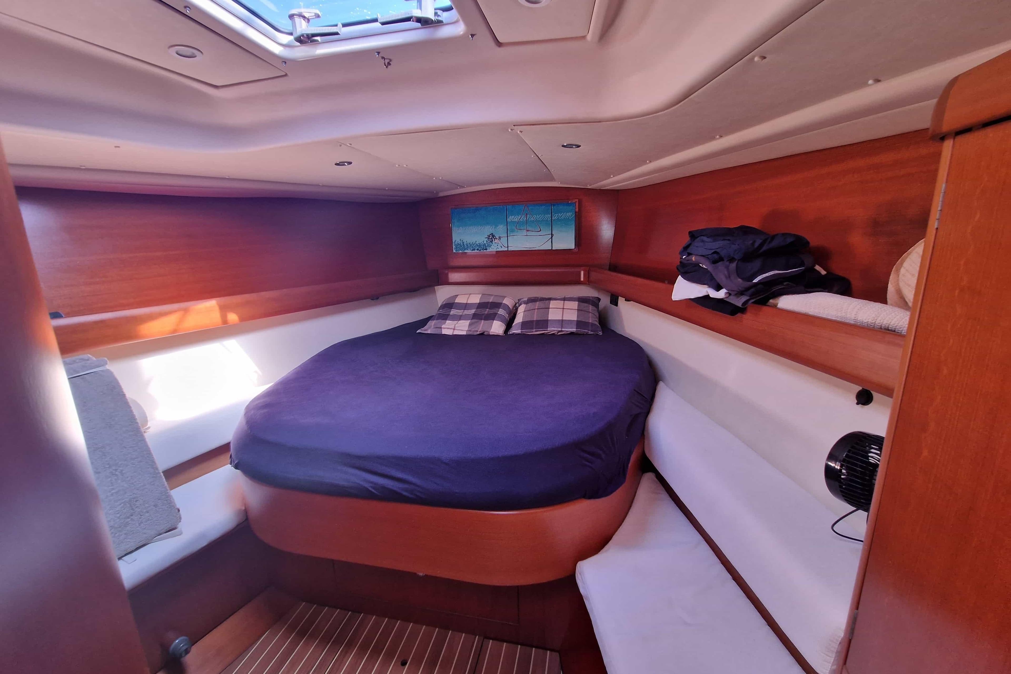 Cozy cabin interior of 2003 Grand Soleil 45 sailboat with wooden finish and skylight.