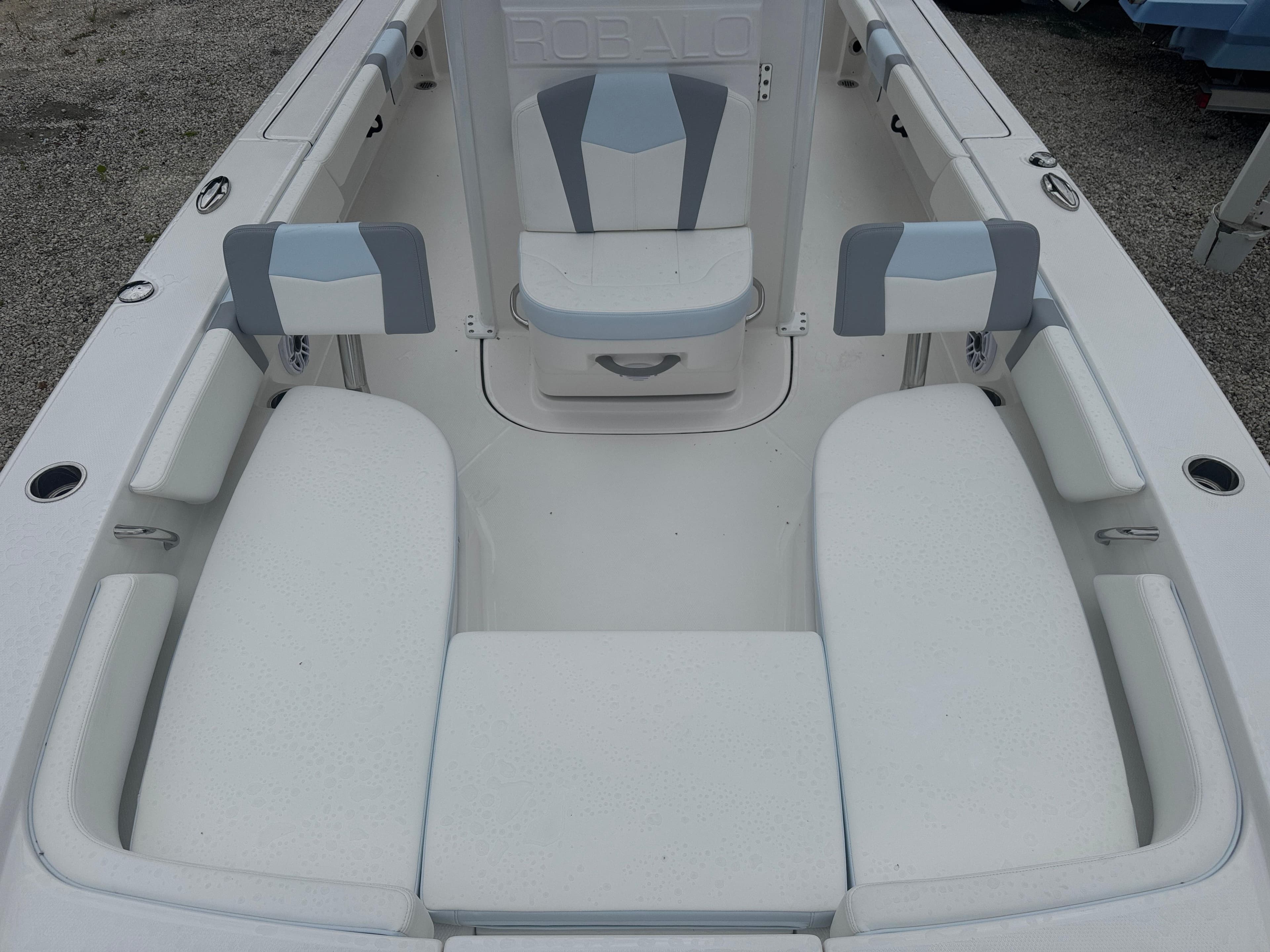 2025 Robalo 246 Cayman boat interior with white cushioned seating and sleek design.
