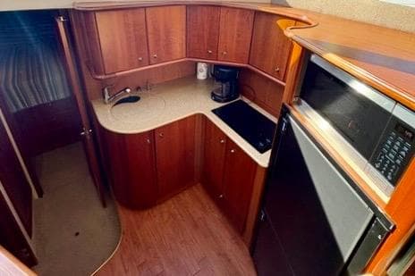 2008 Silverton 36 Convertible yacht kitchen with wood cabinetry and modern appliances.