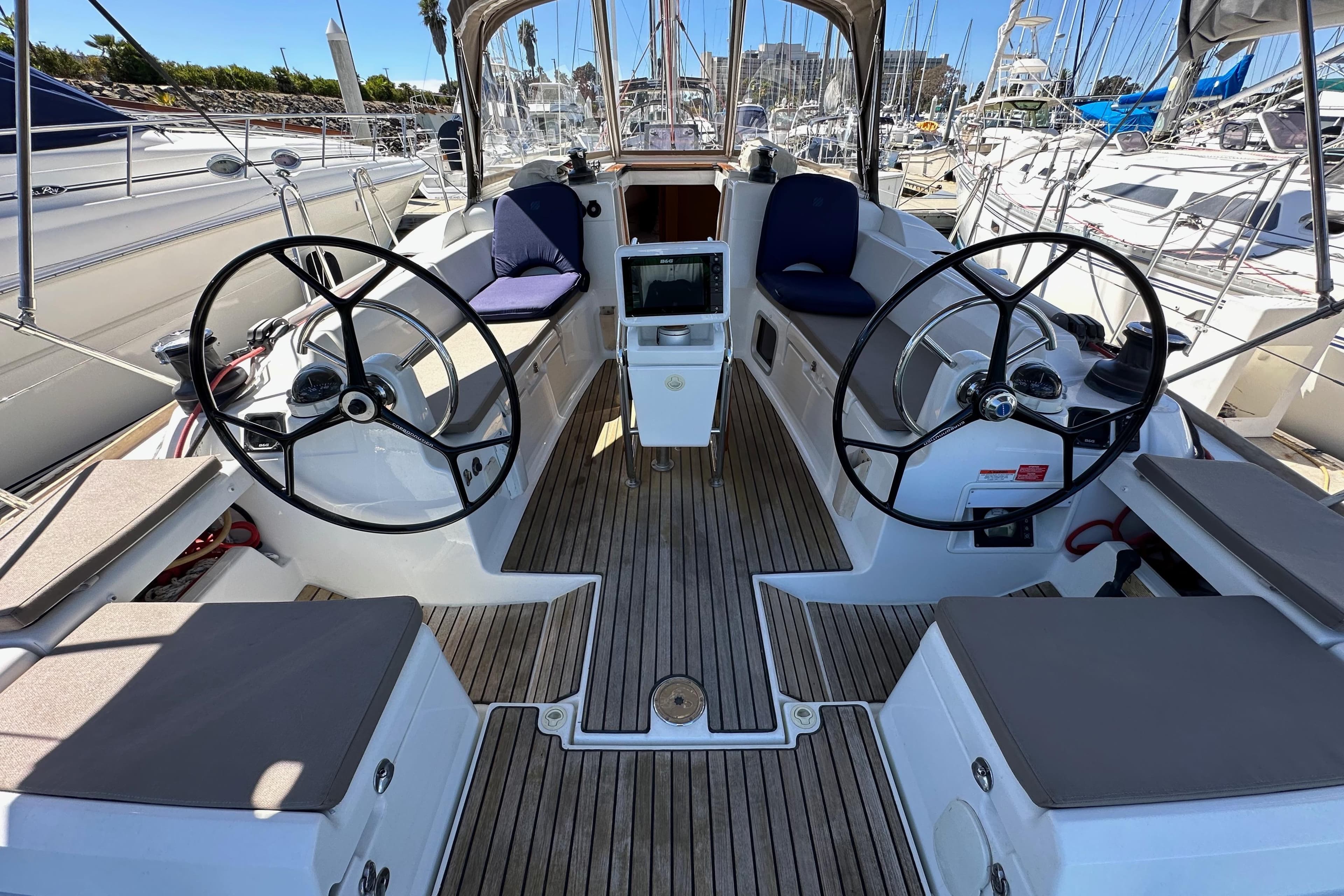 Cockpit of 2015 Jeanneau Sun Odyssey 409 sailboat with dual steering wheels.