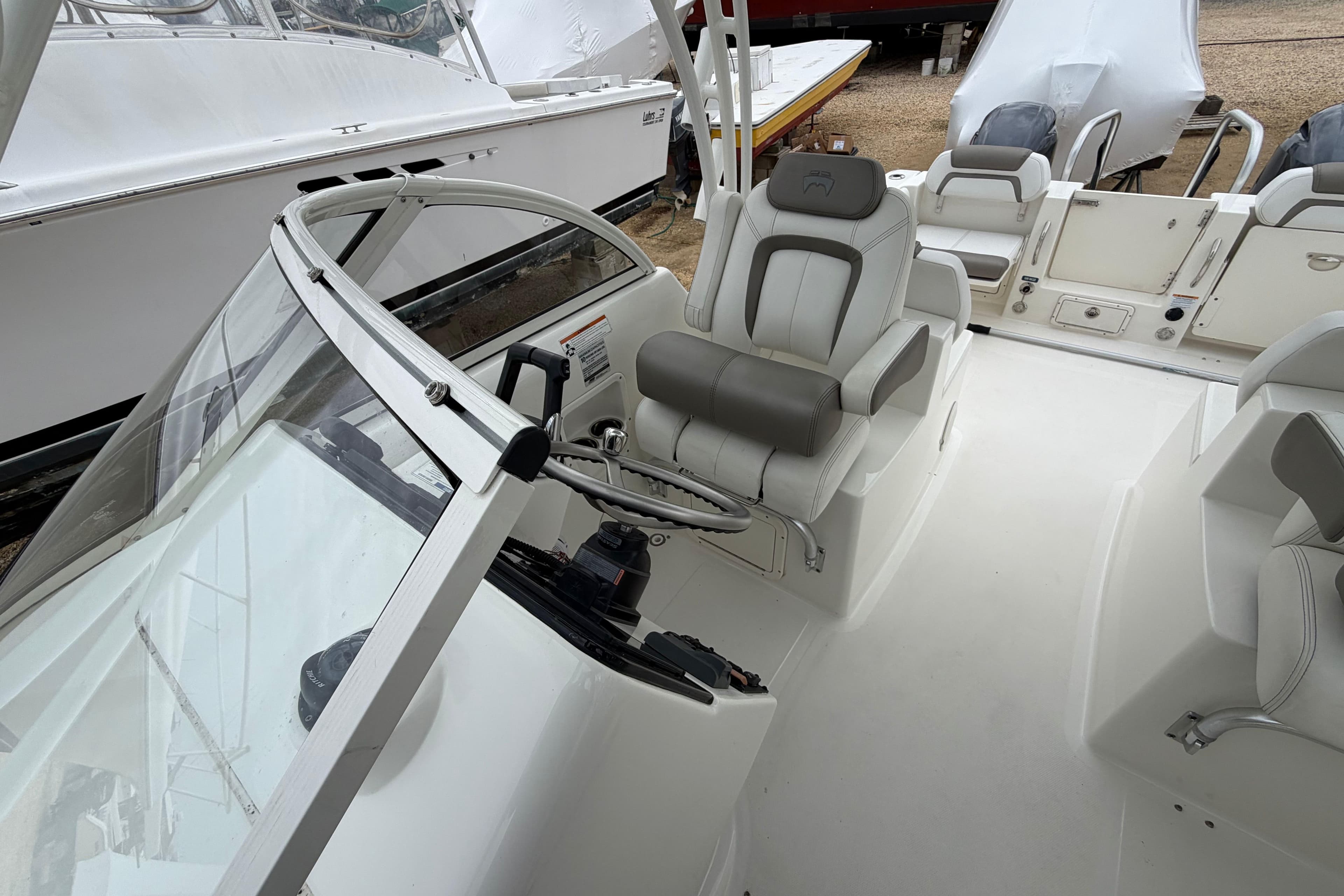2019 World Cat 255 DC boat interior with steering wheel and seating.