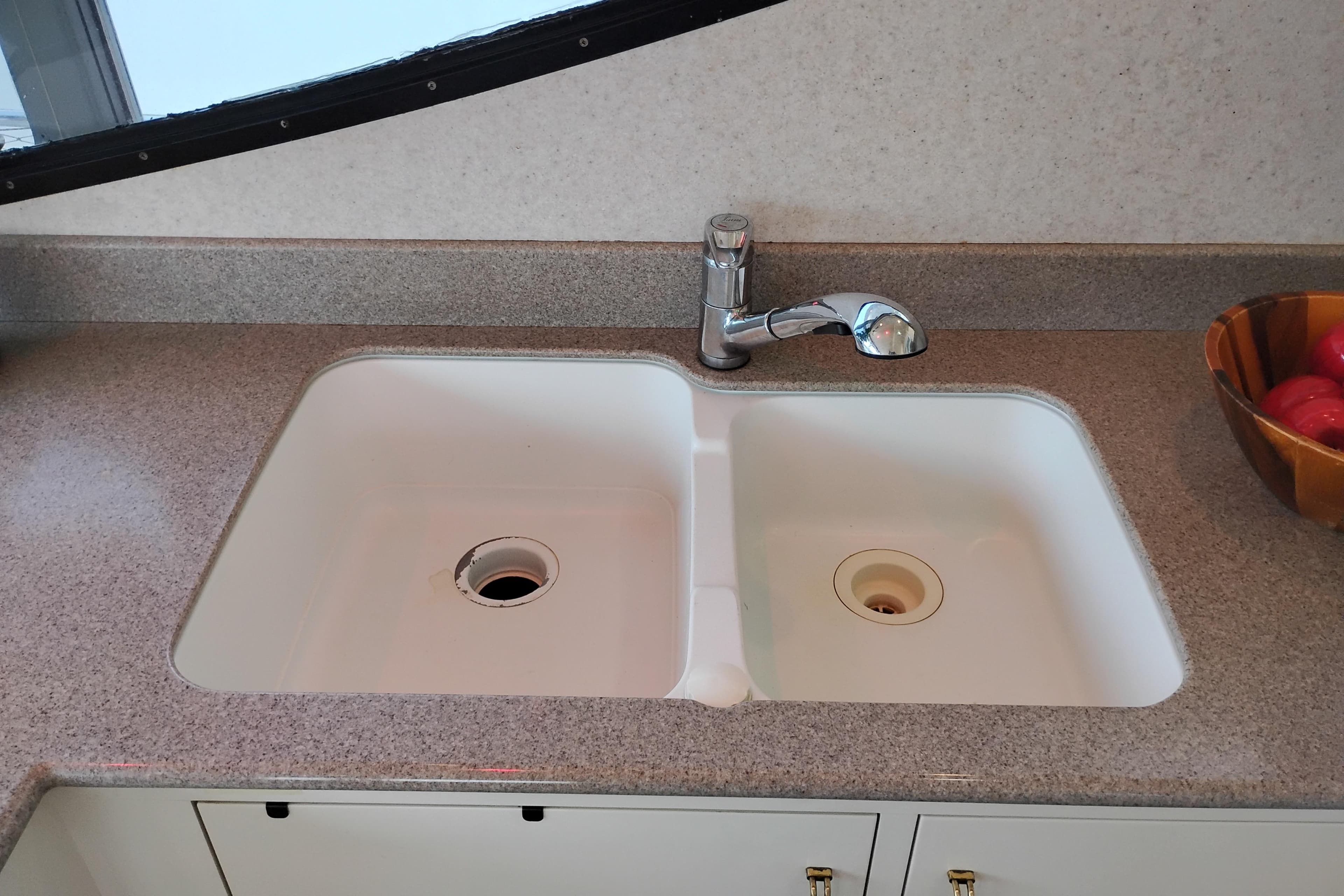 Kitchen sink and faucet on 1995 Queenship 62 Pilothouse Motor Yacht.