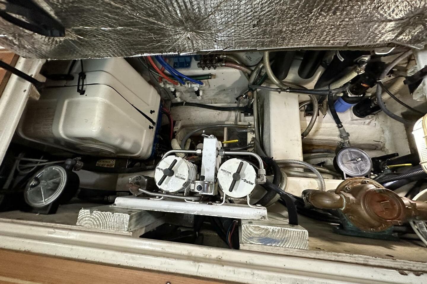 Engine compartment of 2008 Catalina Morgan 440 sailboat, showcasing mechanical components and wiring.