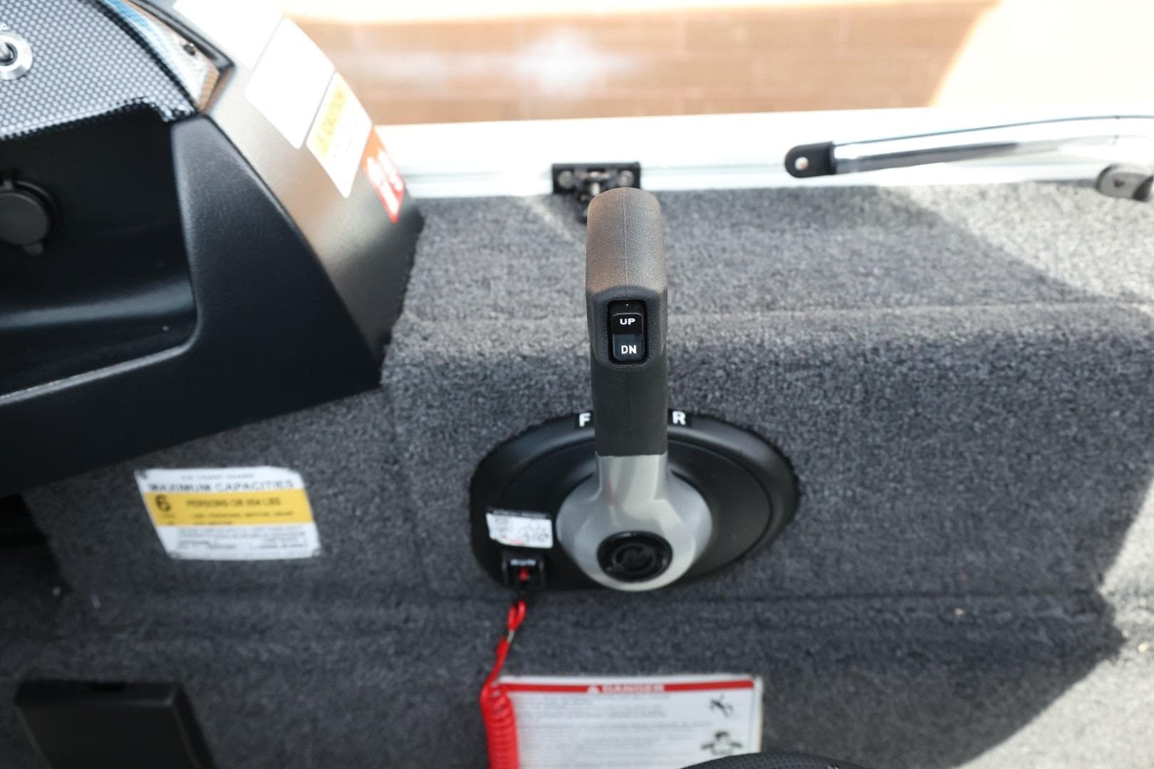 Control lever of 2026 Lowe Fishing Machine 1675 WT boat interior.