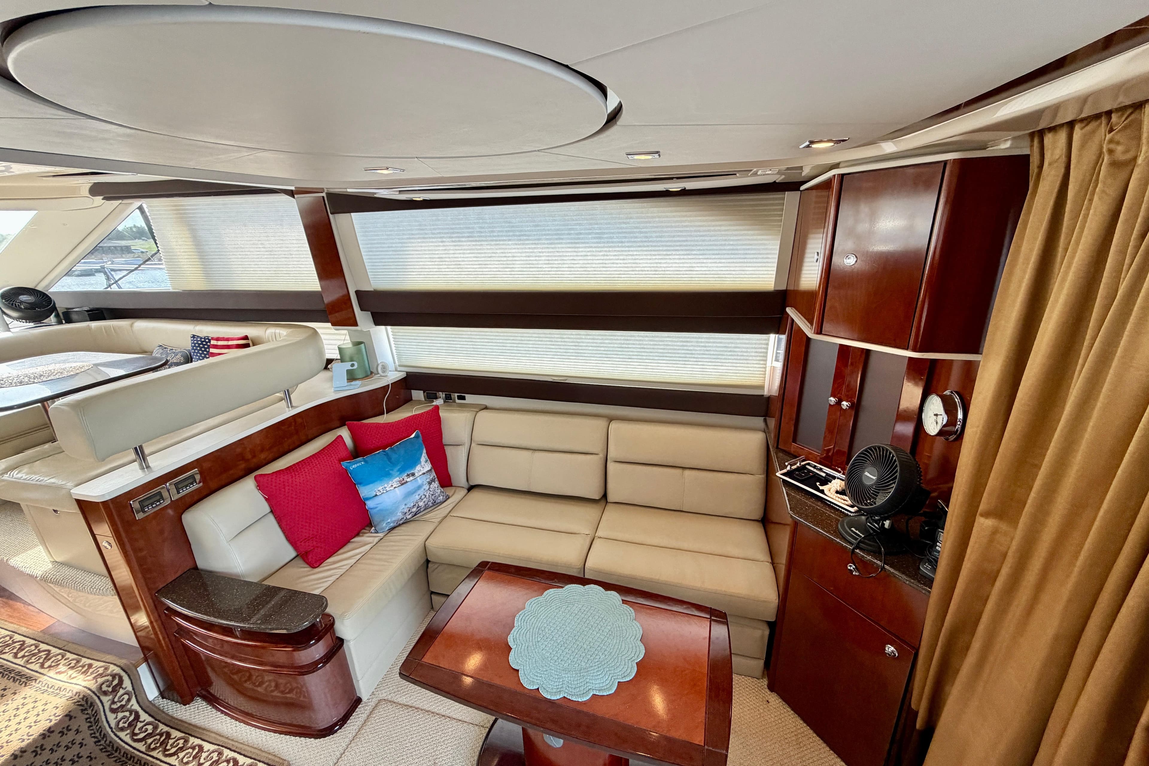 Luxurious interior of a 2011 Meridian 441 Sedan yacht with elegant seating and wood finishes.