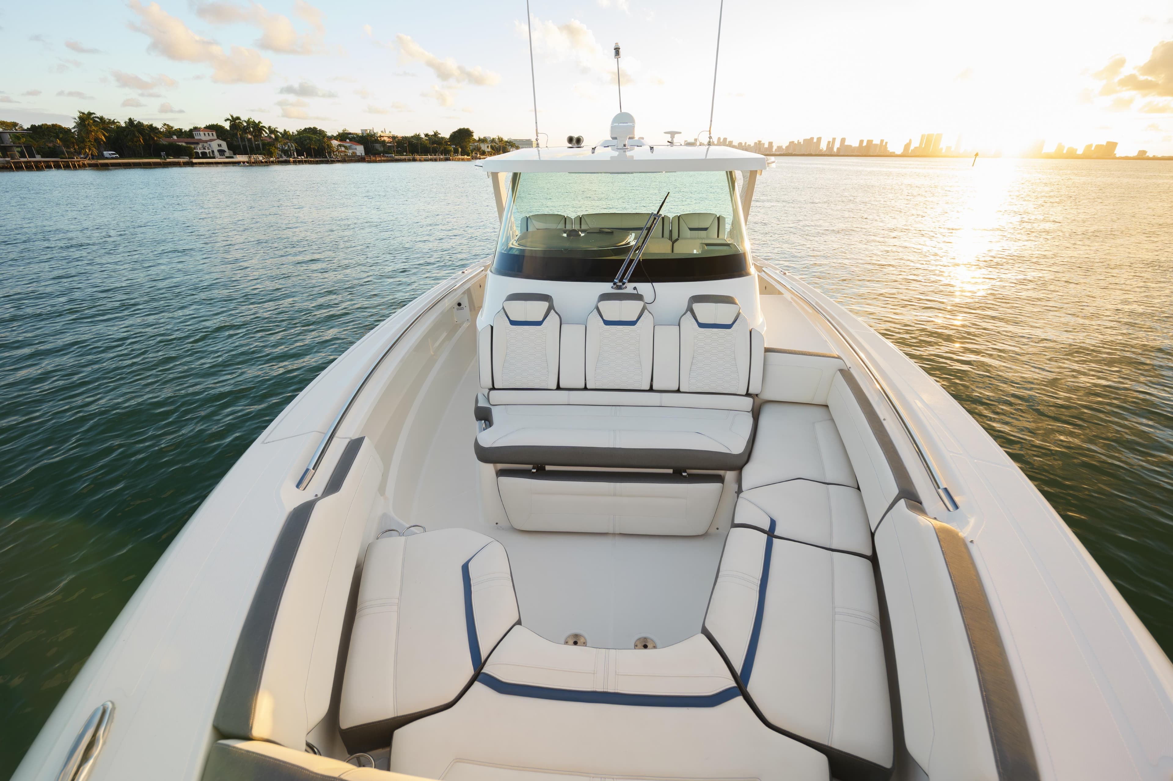 2020 Tiara Yachts 43 LS on serene water at sunset, showcasing luxurious seating.