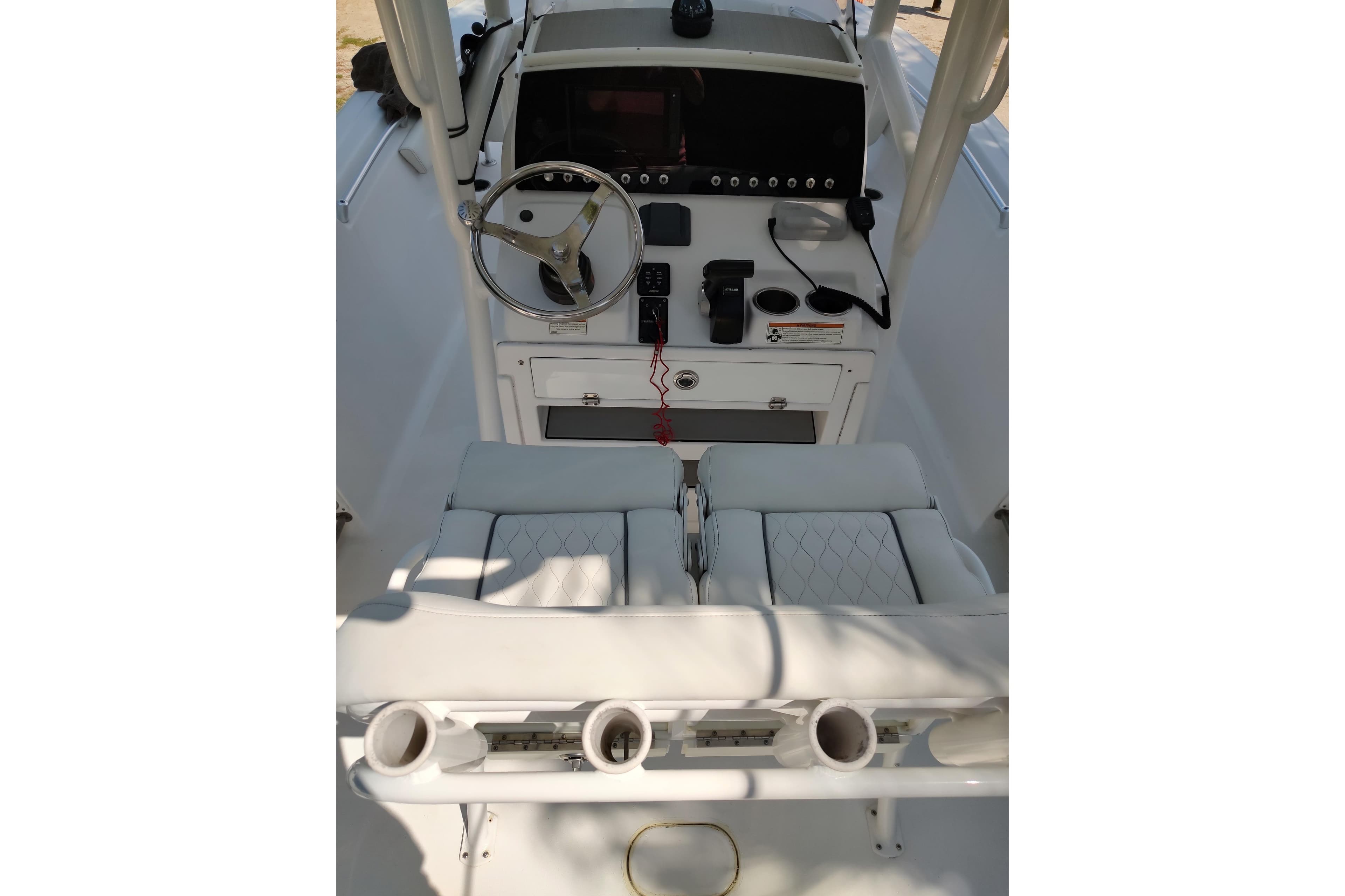 2020 Sportsman Heritage 211 Center Console boat interior with steering wheel and seating.