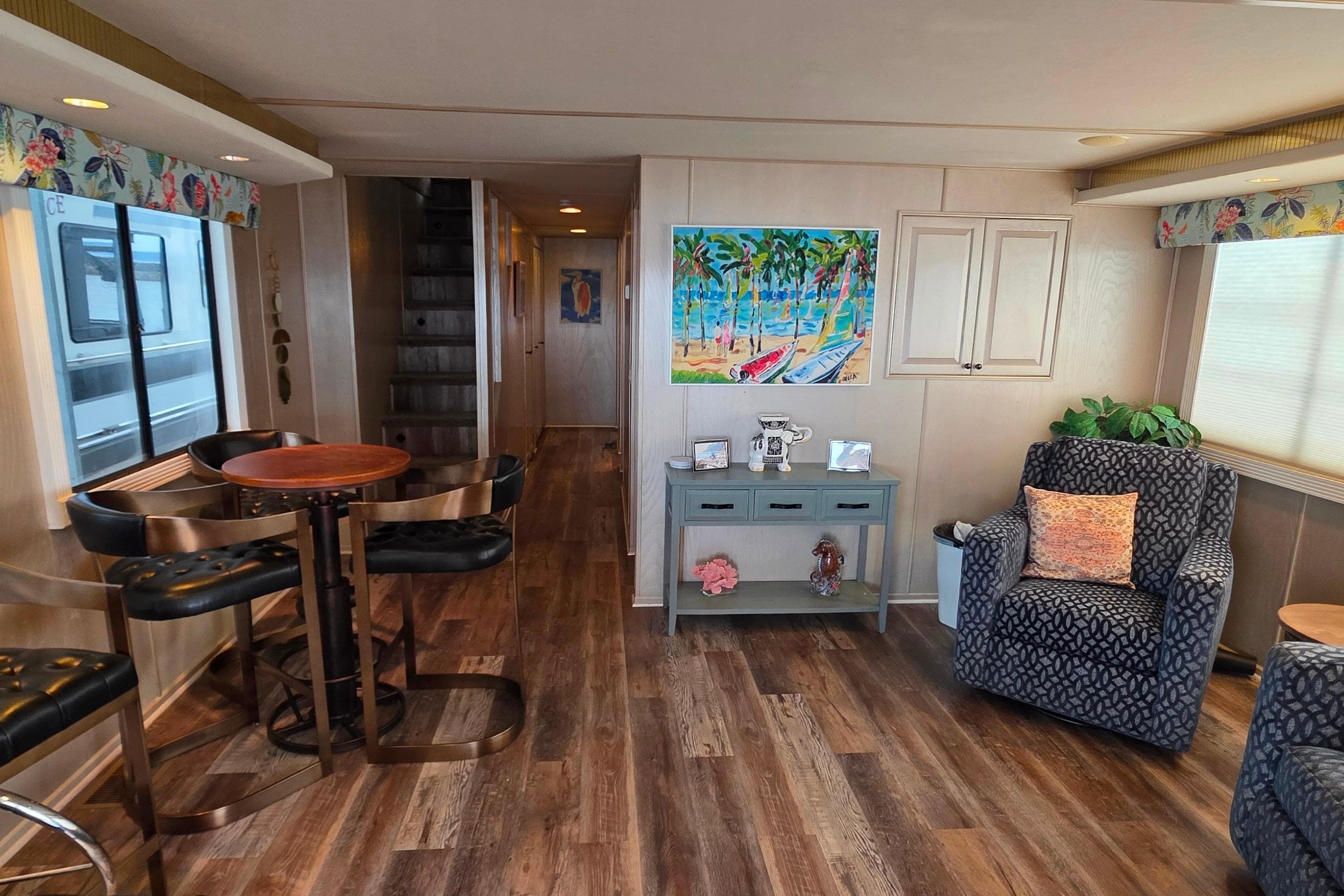 Interior of 1999 Stardust Cruisers 16x60 houseboat with cozy seating and vibrant decor.