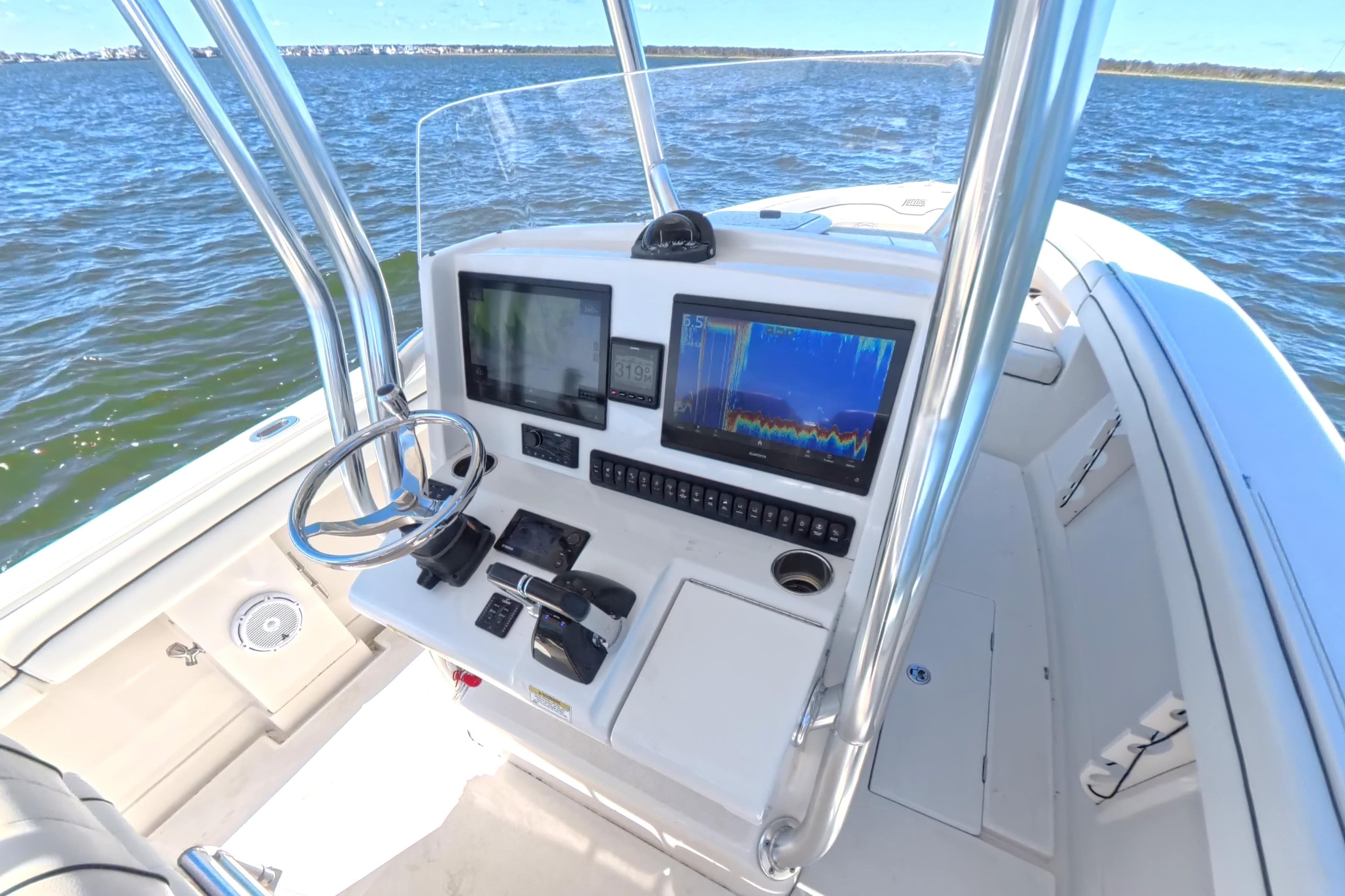 2014 Jupiter 30 FS boat console with navigation screens on open water.