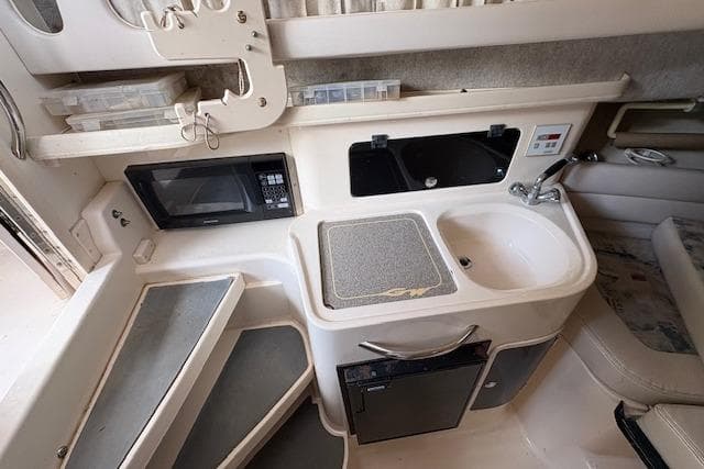 2003 Grady-White Marlin 300 boat interior with kitchenette, microwave, sink, and compact design.
