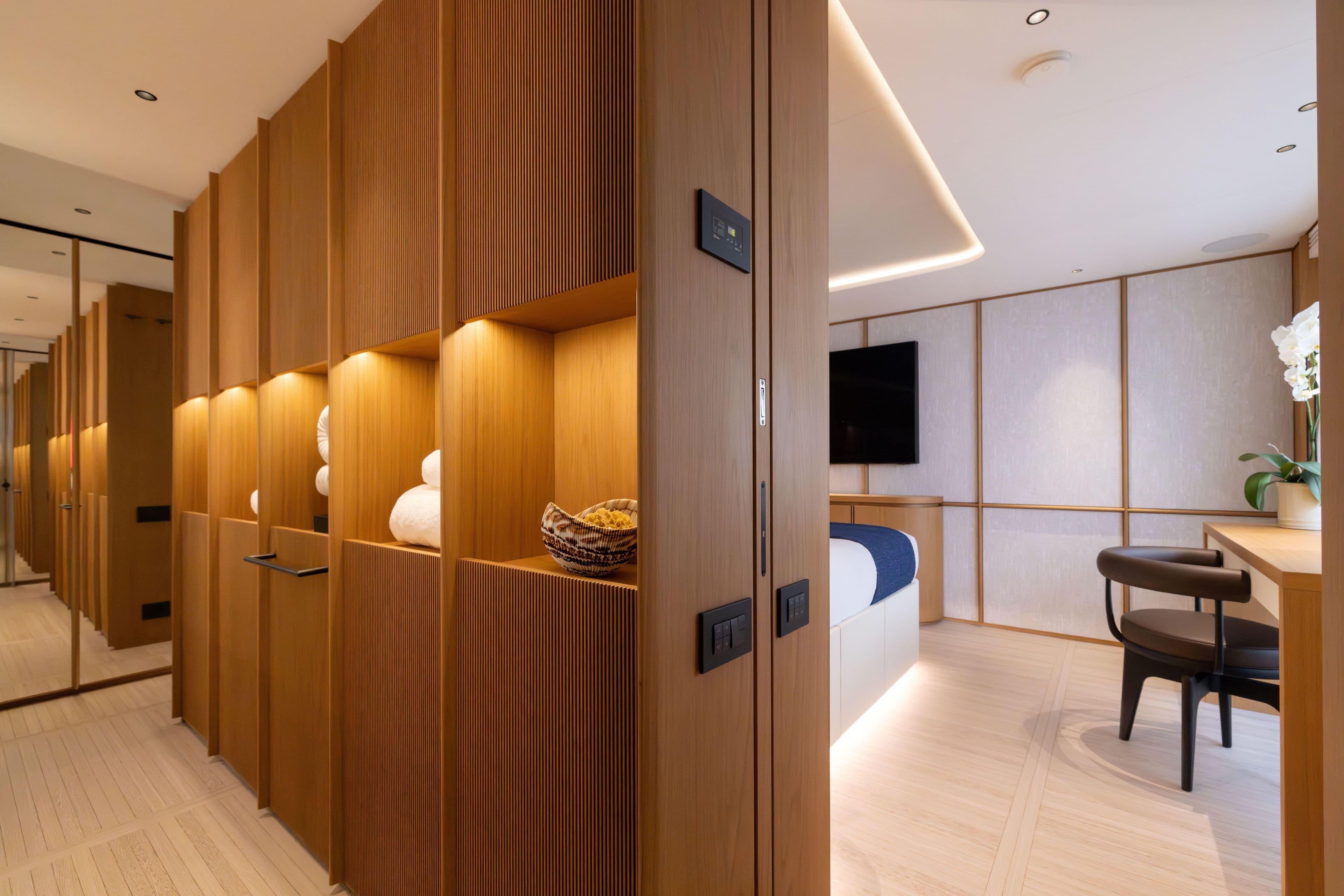 Luxurious interior of 2024 Benetti Oasis 34M yacht, featuring elegant wood paneling and modern decor.
