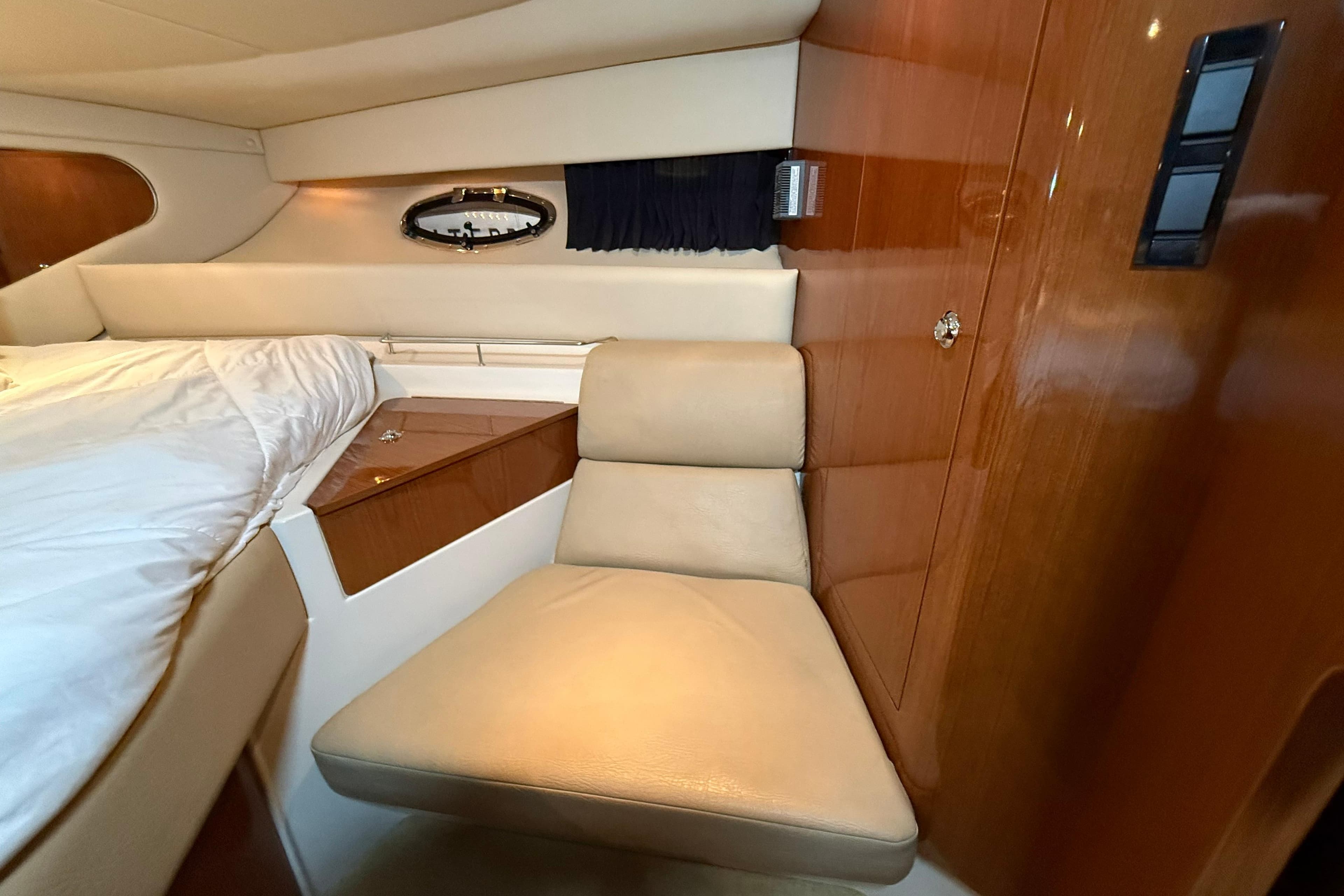 Interior of 2007 Regal Commodore 3760 IO yacht with beige seating and wood paneling.