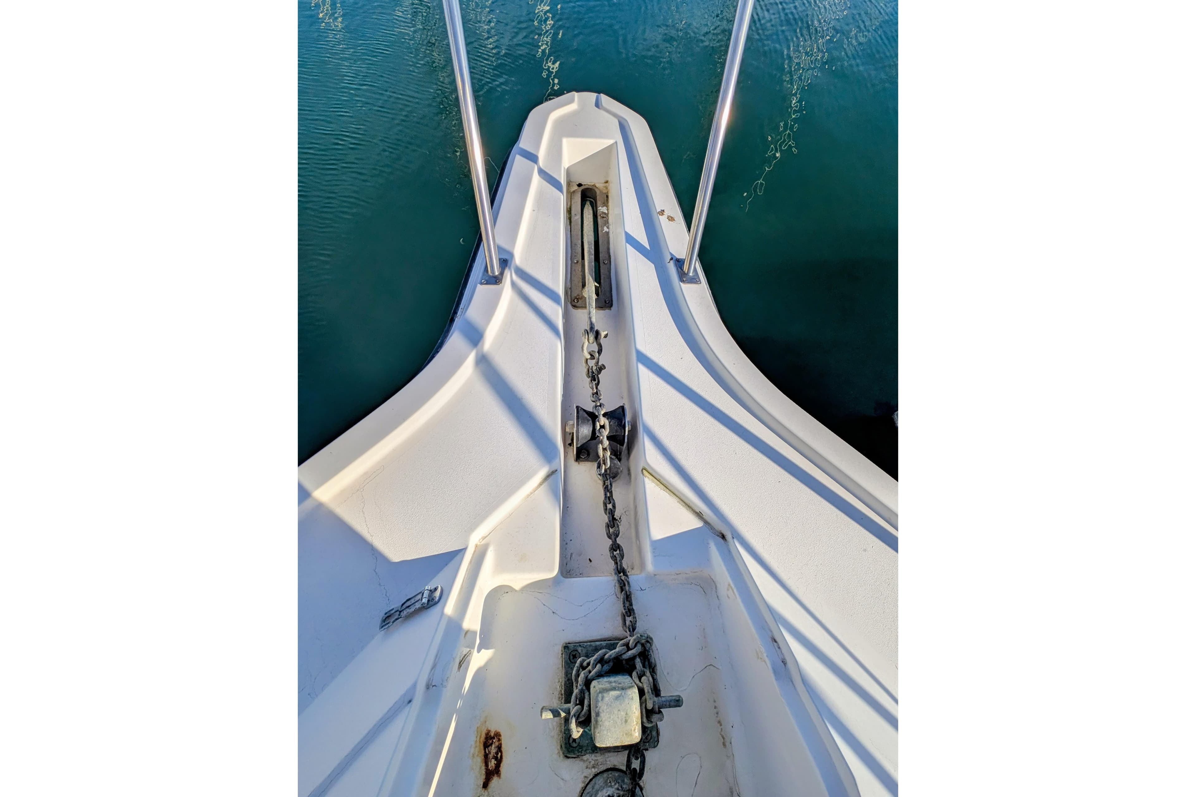 1994 Cruisers Yachts 3850 Aft Cabin bow with anchor chain and calm water.