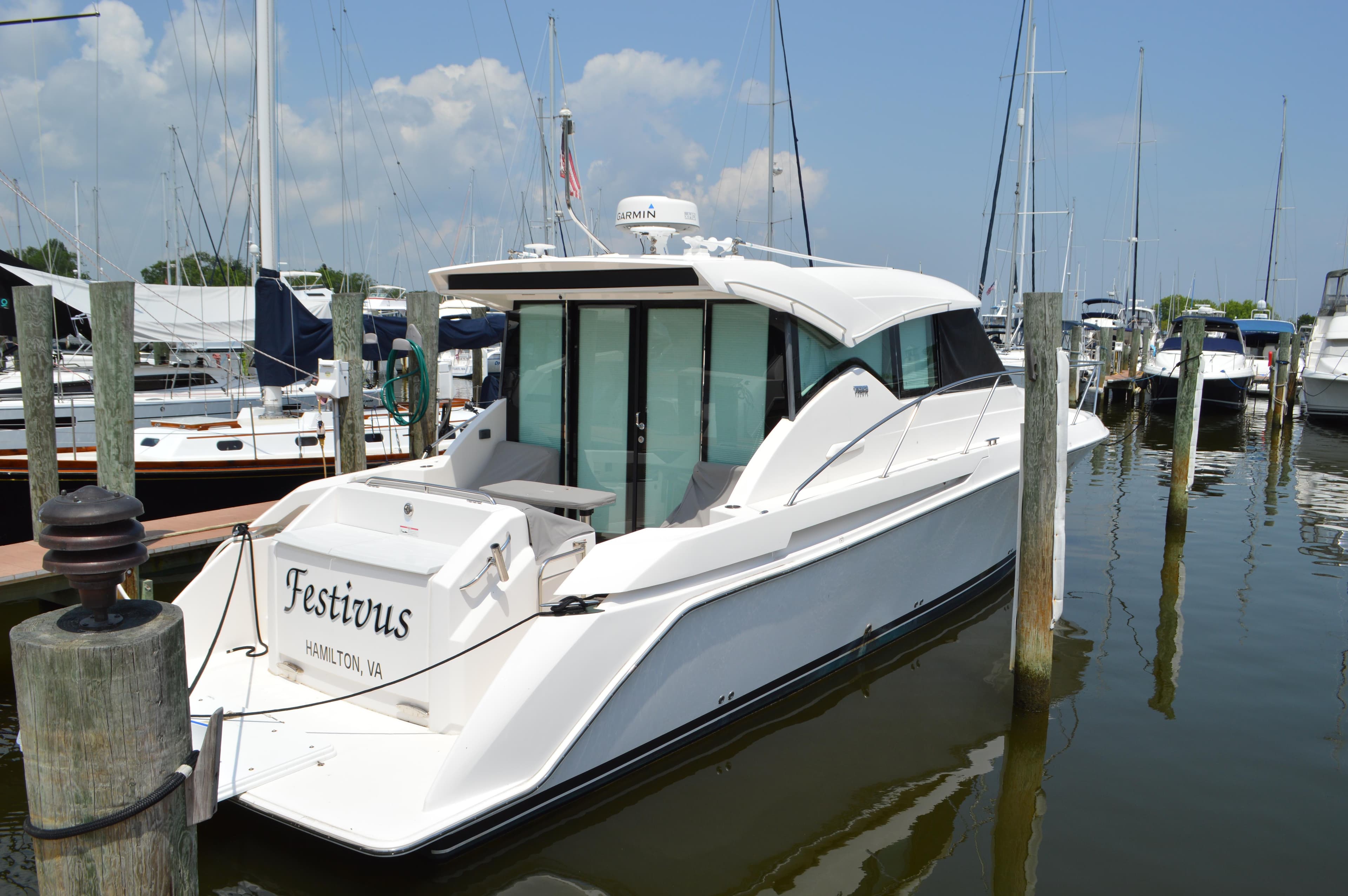 2019 Tiara Yachts C39 Coupe docked in a marina, rear view.