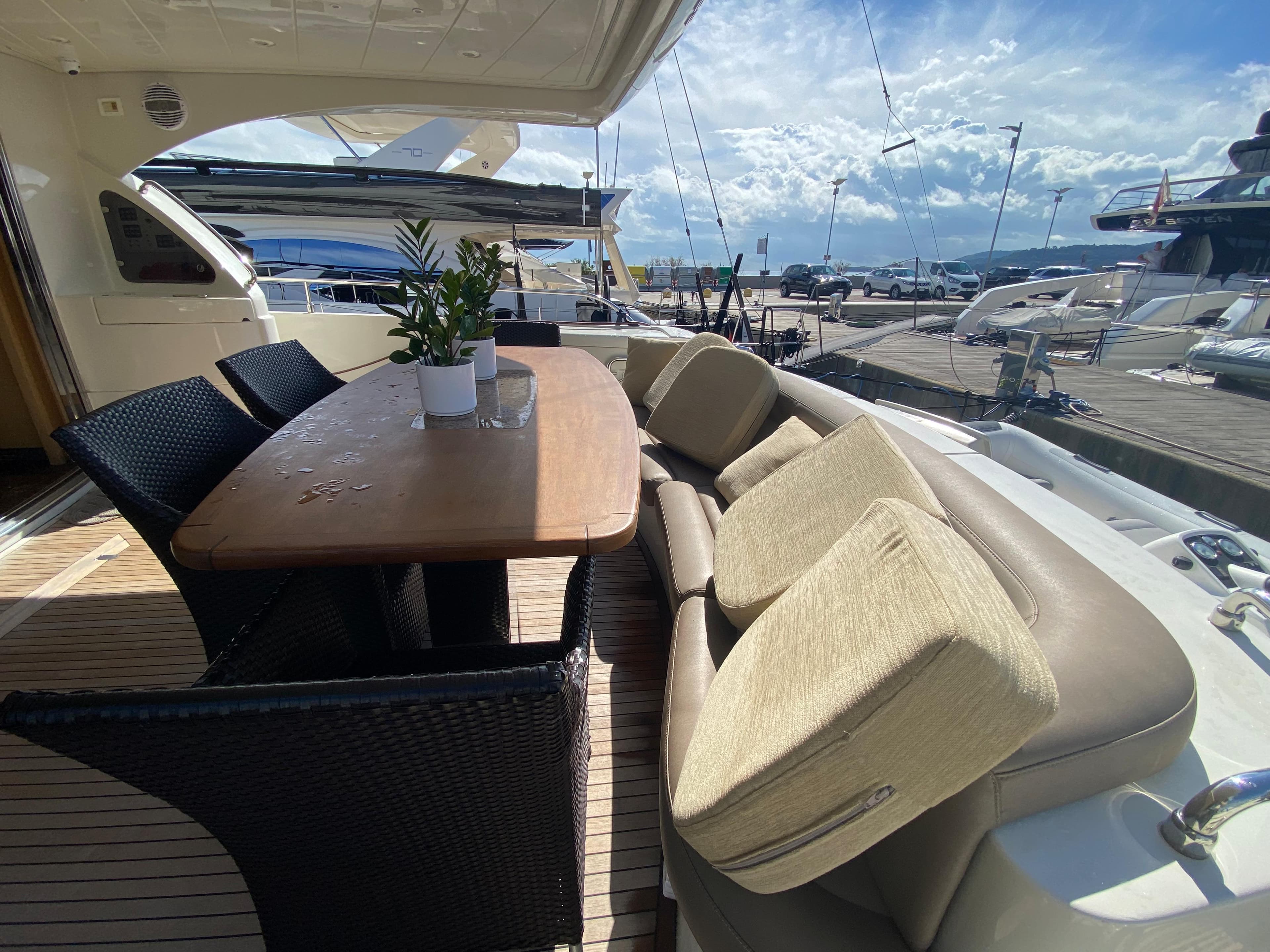 Luxurious 2008 Dominator 680 yacht with elegant outdoor seating and dining area.