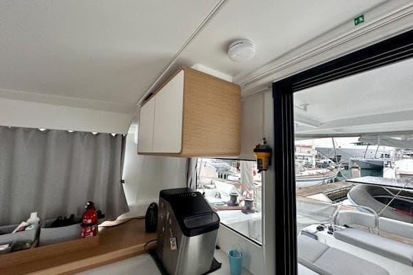 Interior of 2025 Excess 14 yacht with modern kitchen and marina view.
