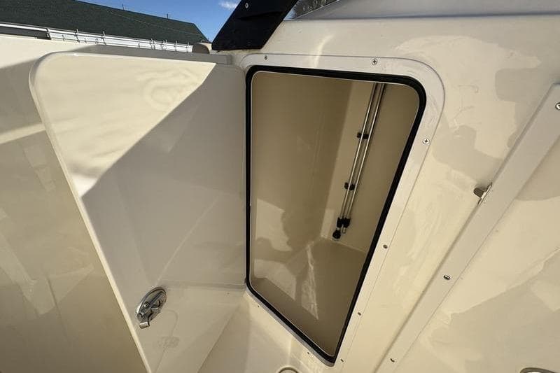 Open storage compartment on 2026 Scout 222 Dorado boat, showcasing interior space.