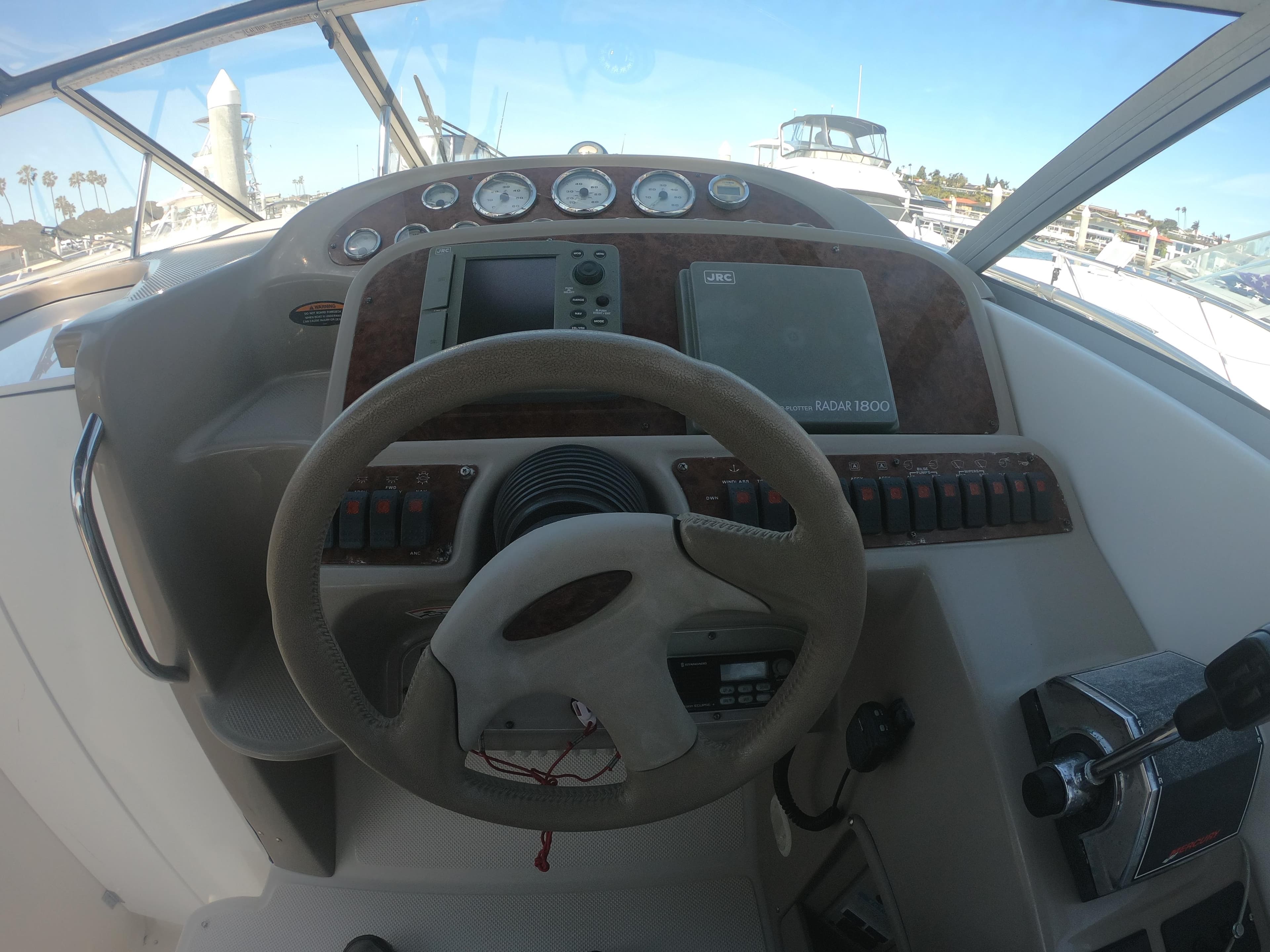 2001 Bayliner 3055 Ciera boat dashboard with steering wheel and navigation instruments.